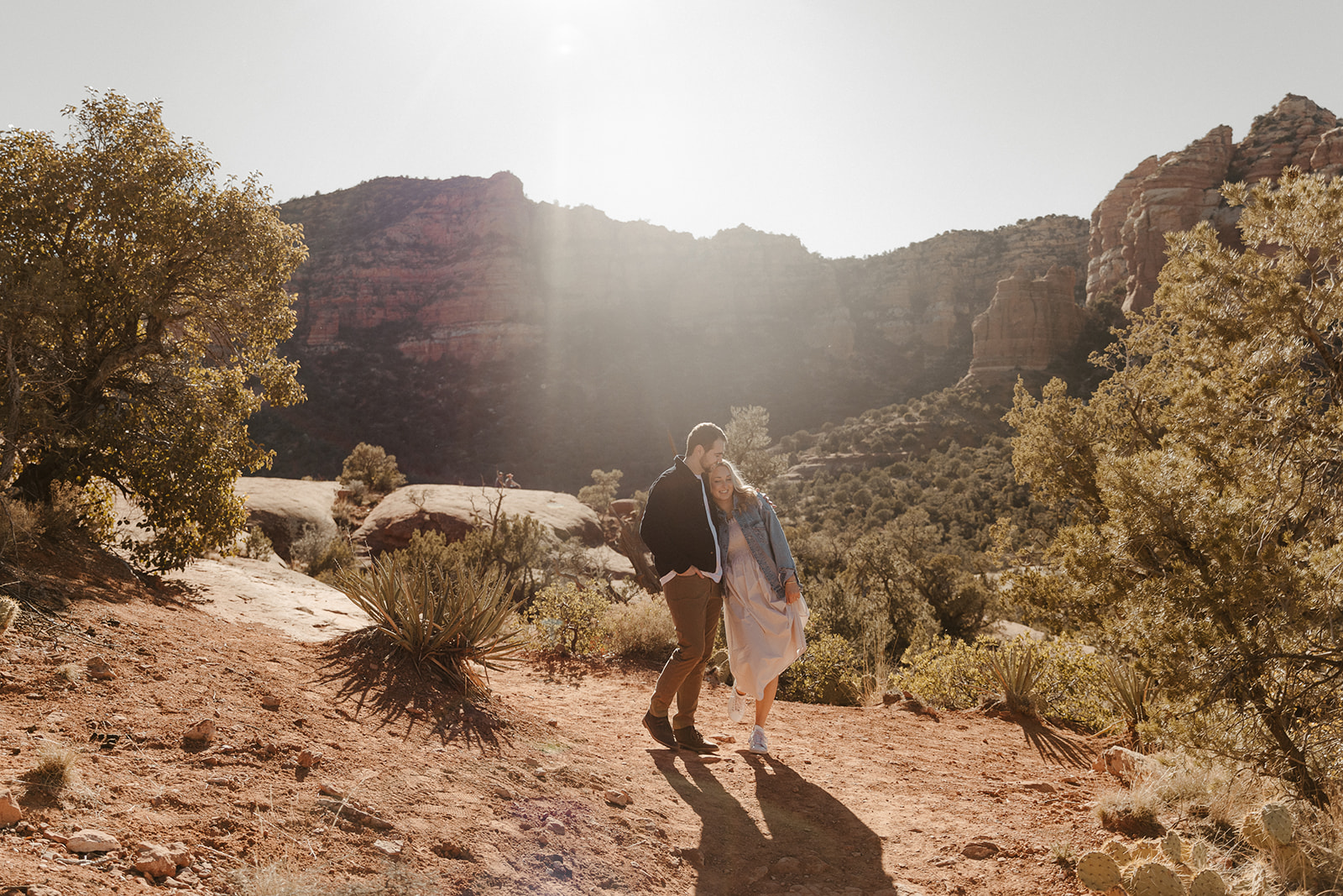 engaged couple standing together in the desert during sedona engagement photos