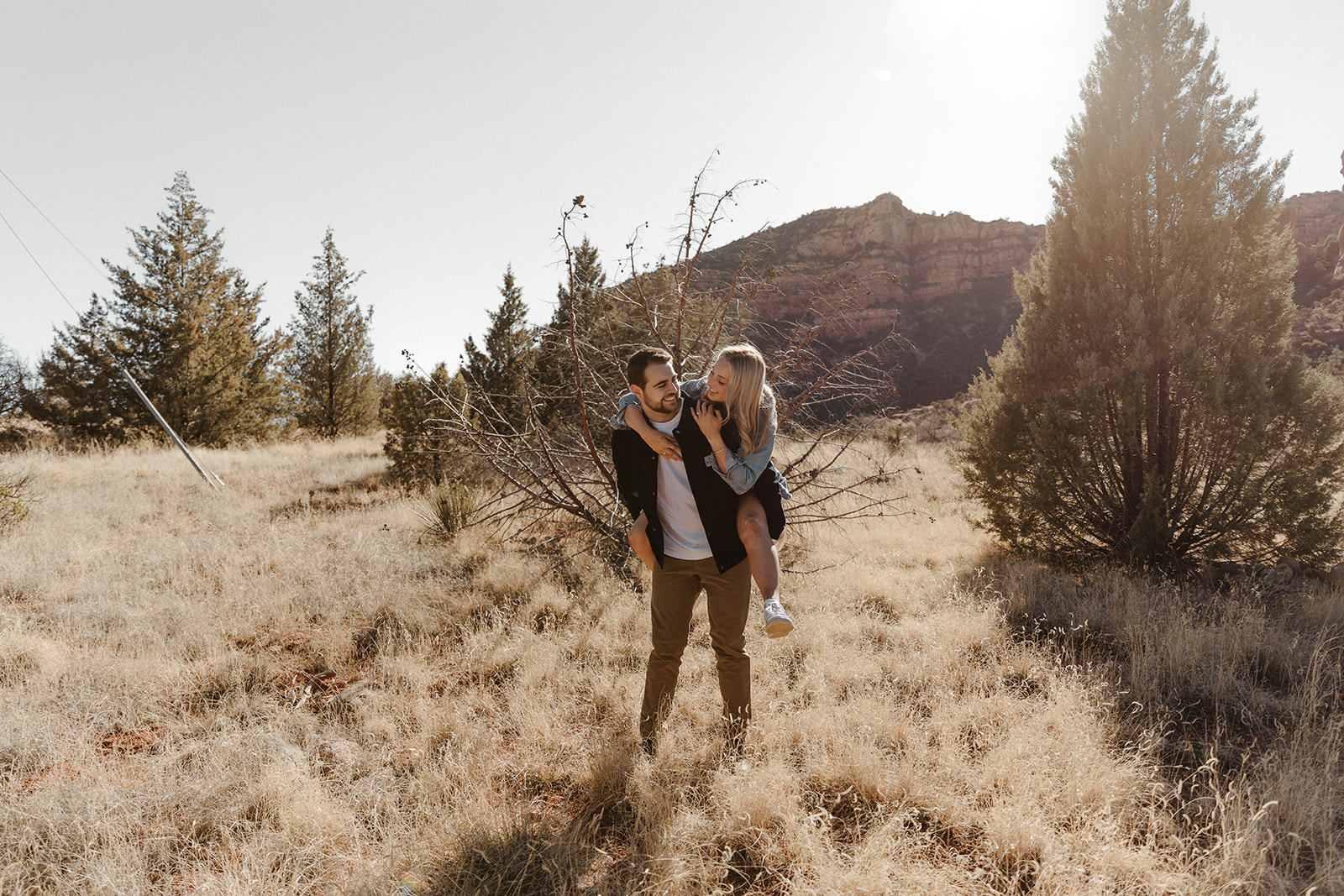 finace on other fiances back in the grass during sedona engagement photos