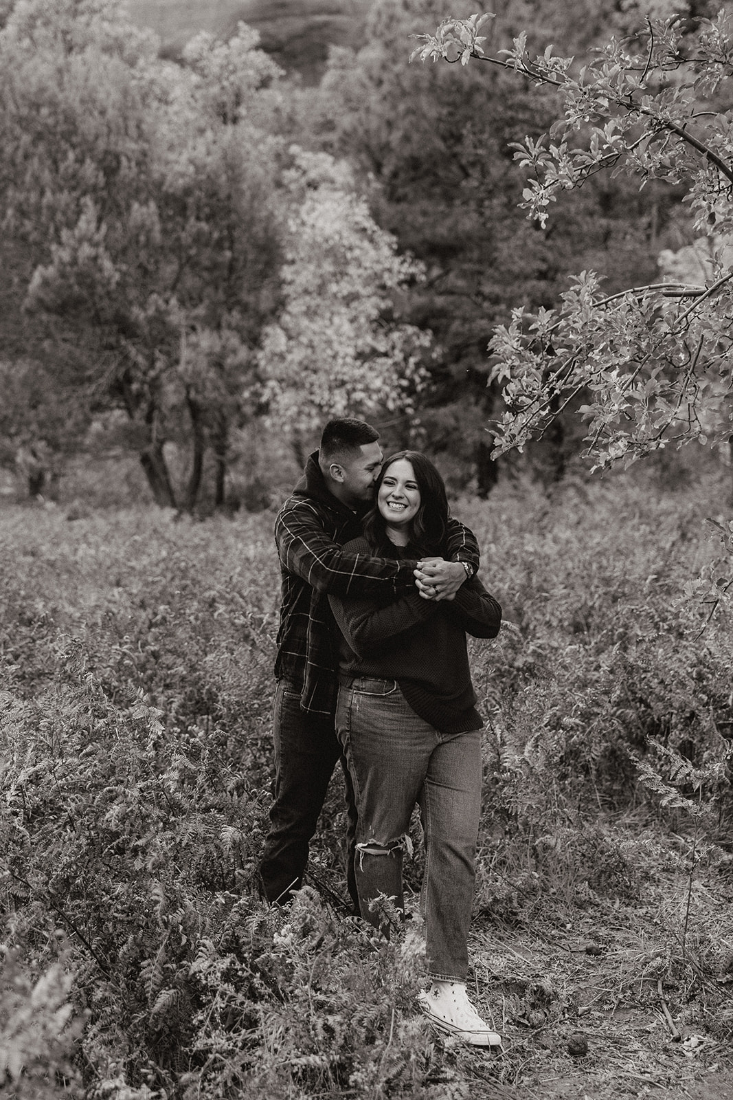Gorgeous couple share a hug and laugh during their dreamy west fork trail in Sedona Arizona engagement photoshoot 
