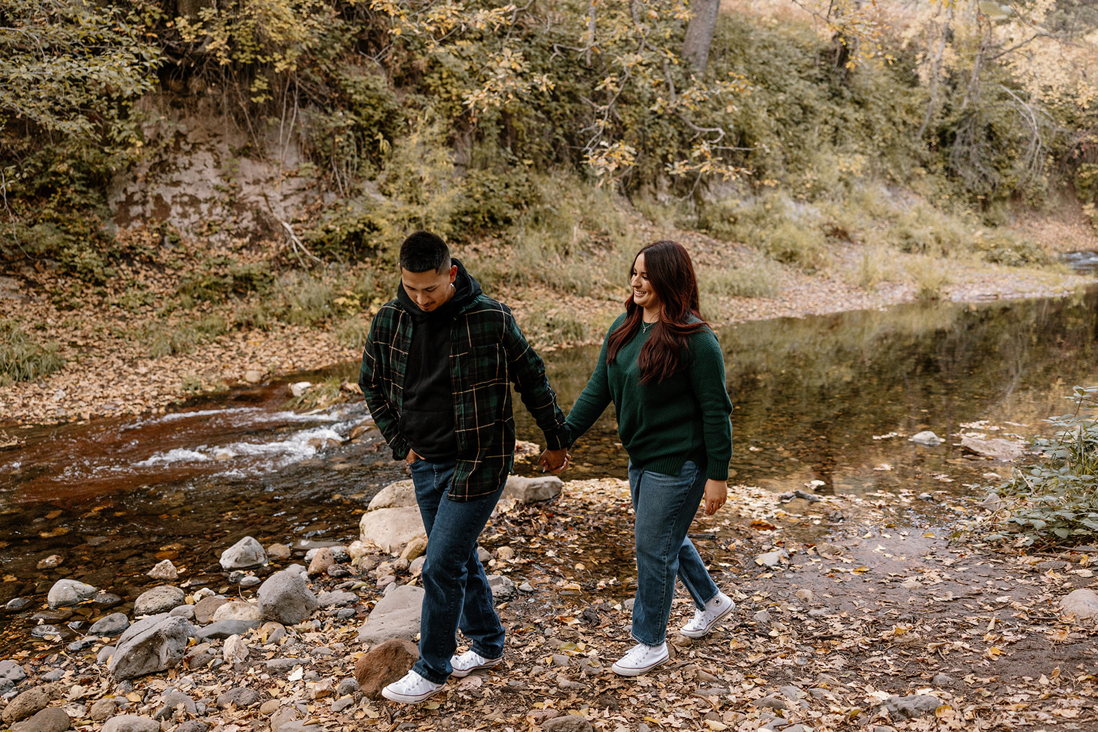 couple walks along the creek during their dreamy Arizona engagement photoshoot