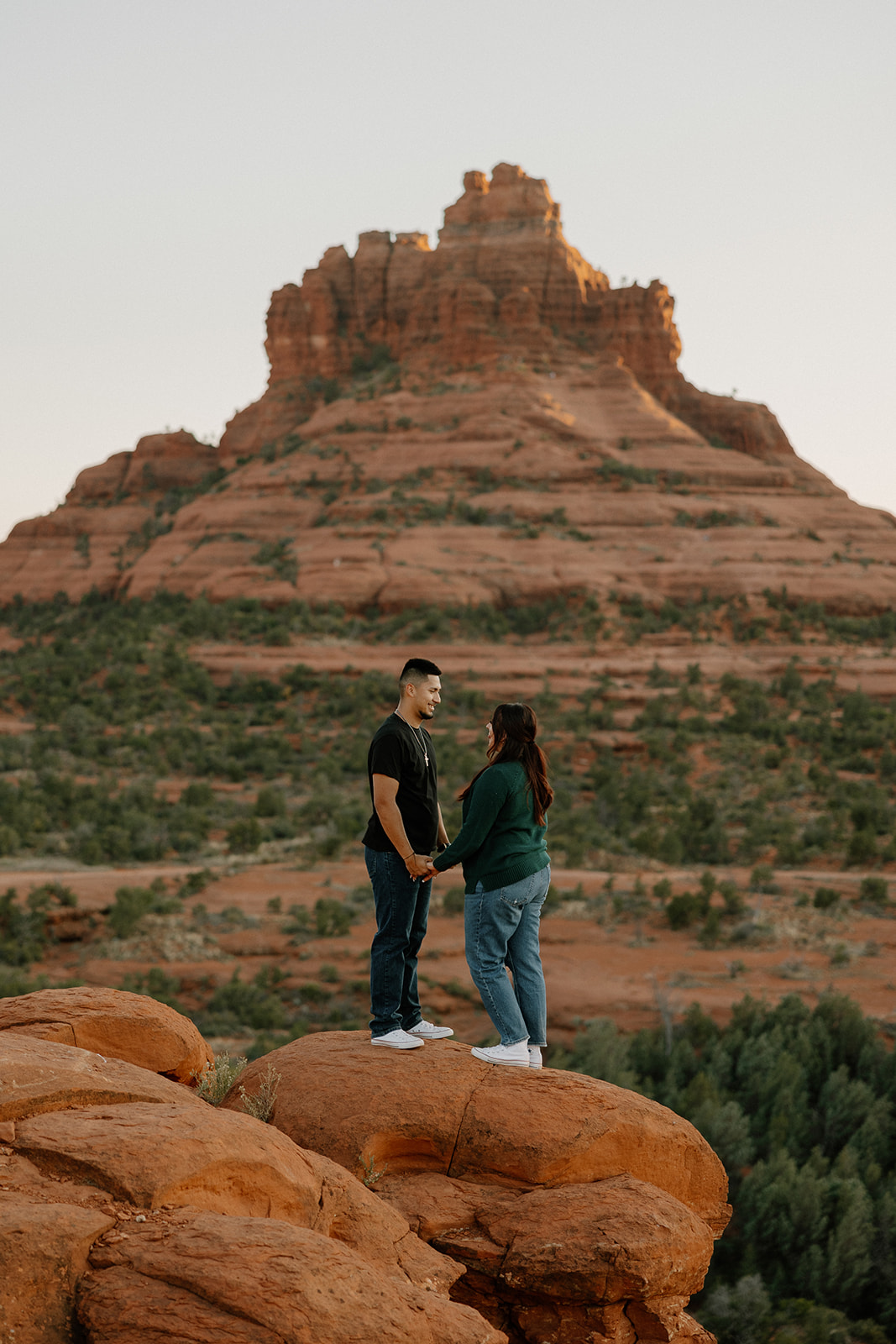 Stunning couple pose with the Arizona mountains in the background during their dreamy west fork trail in Sedona Arizona engagement photoshoot 