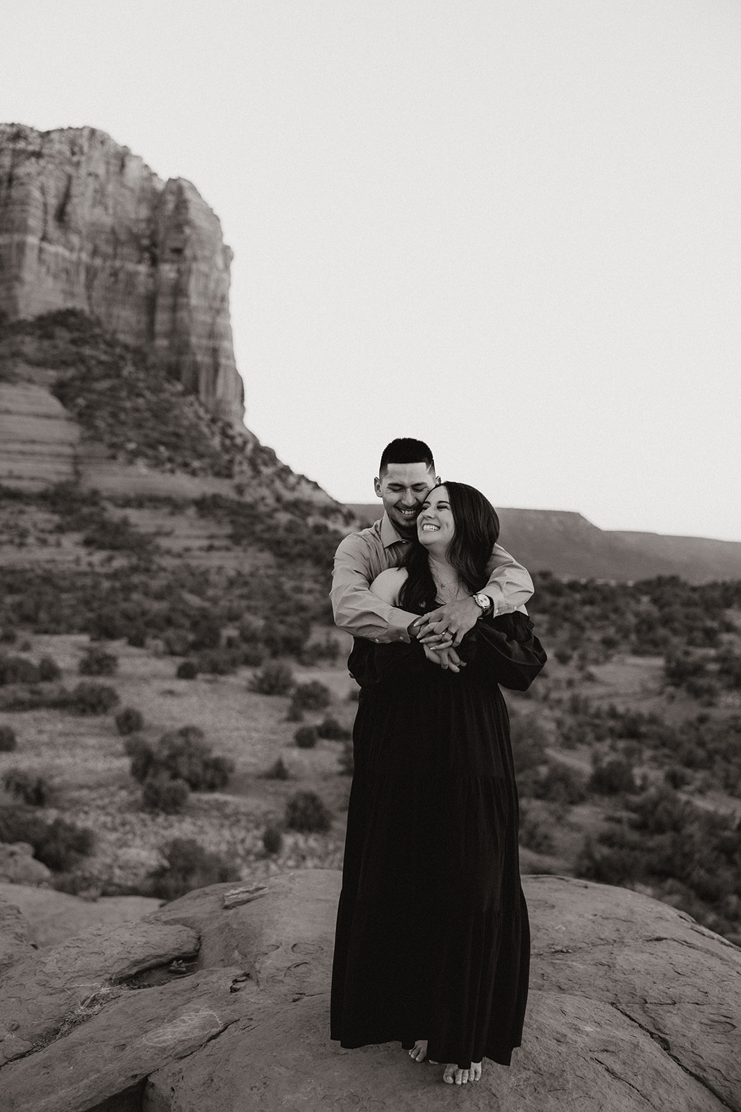 Beautiful couple share a hug with the beautiful Arizona mountains in the backdrop