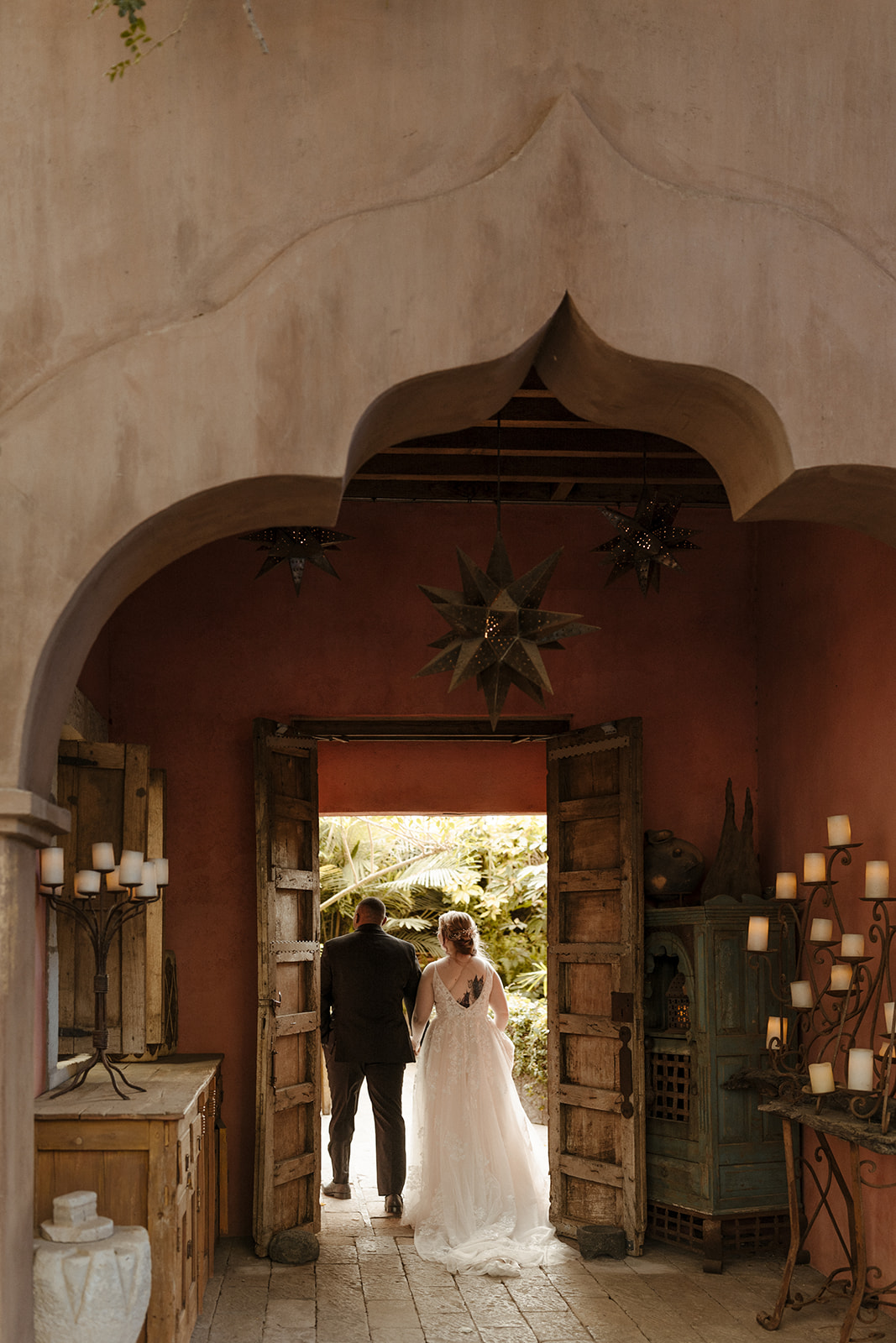 Beautiful bride and groom exits the stunning Boojum Tree Hidden Gardens wedding venue