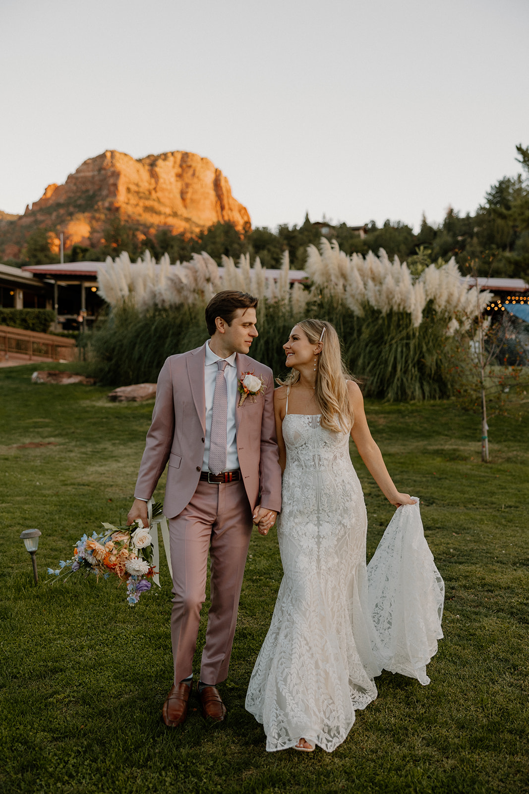 Bride and groom pose in front of the stunning Arizona mountains