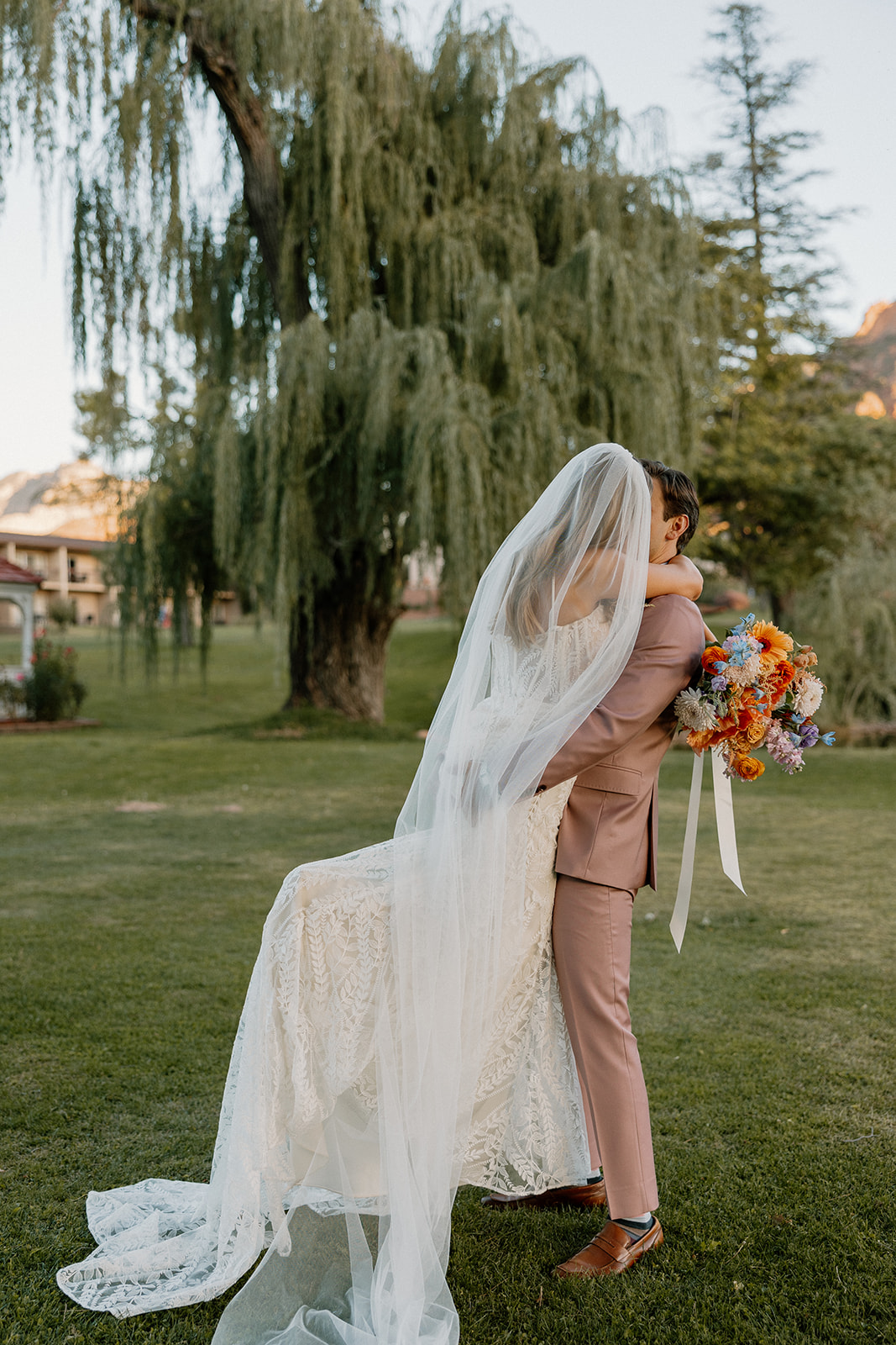 Bride and groom pose together after their dreamy fairy garden Arizona wedding