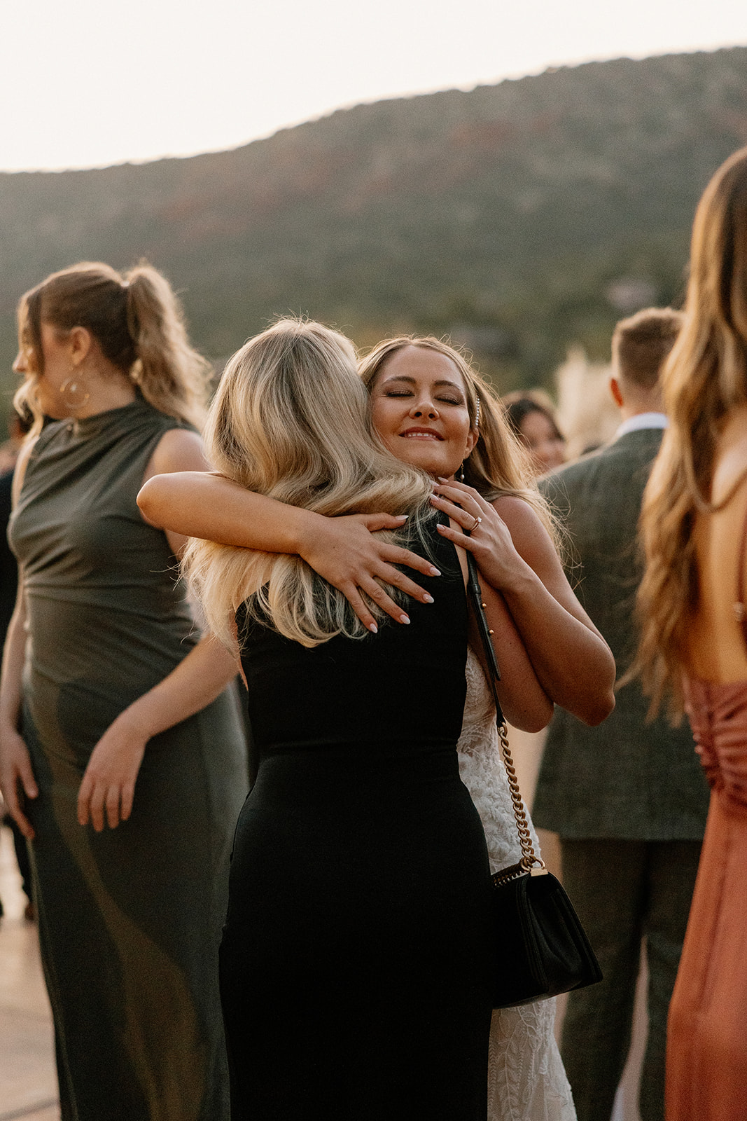 Bride hugs her guests as they enter the stunning reception!