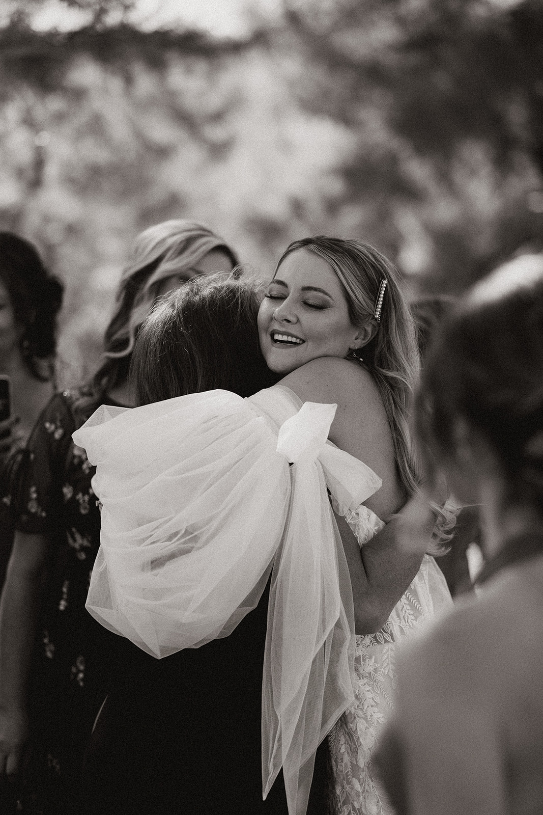 Bride hugs her guests as they enter the stunning reception!