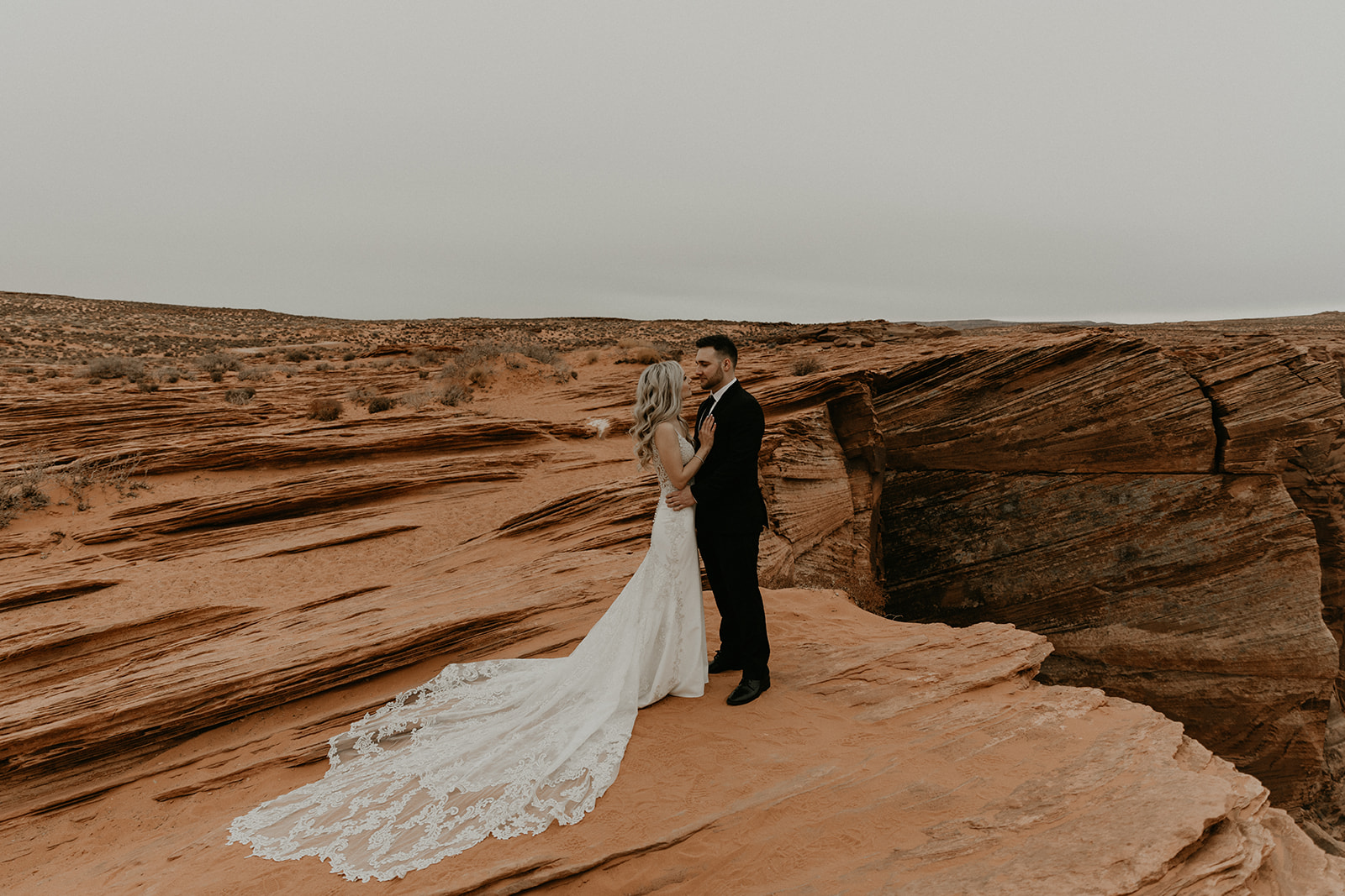 beautiful bride and groom pose together after their stunning Arizona desert elopement
