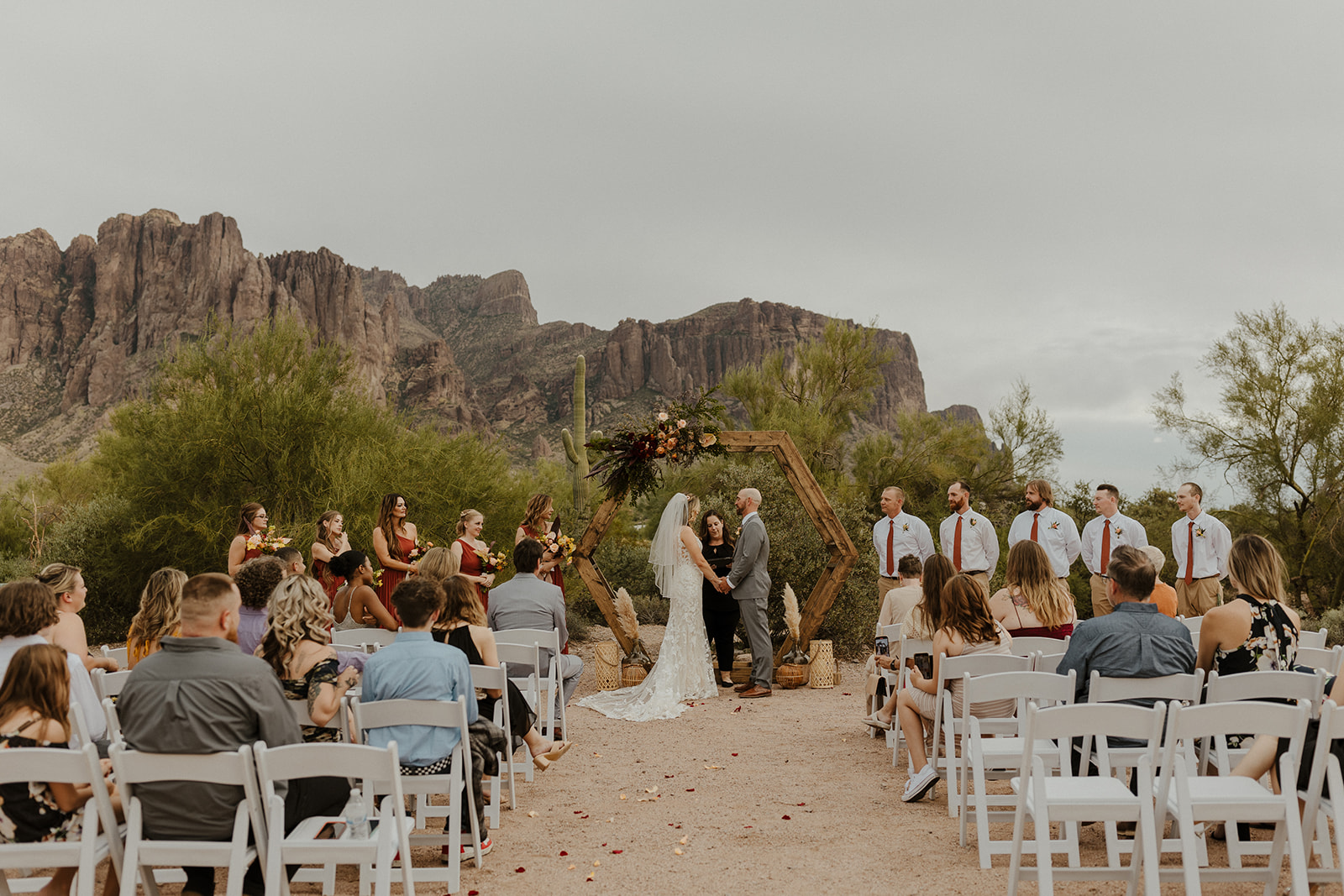 beautiful bride and groom stand against the stunning lost dutchman state park nature
