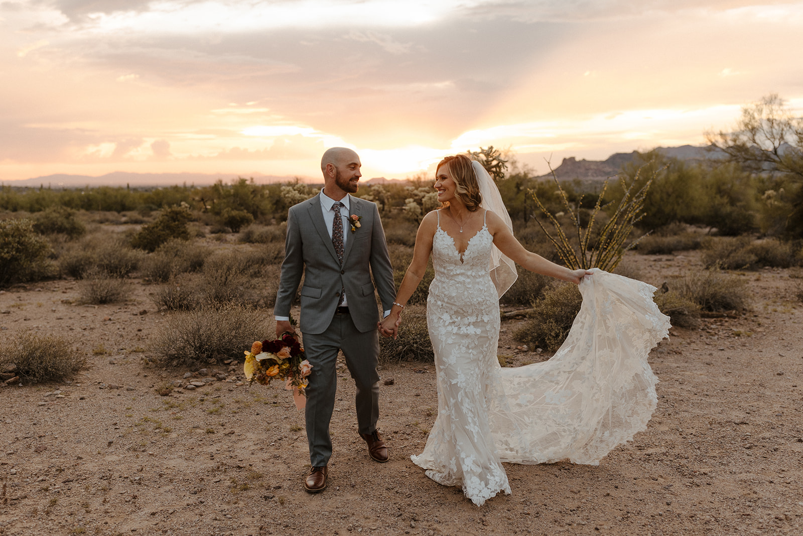 stunning bride and groom pose during golden hour in lost dutchman state park