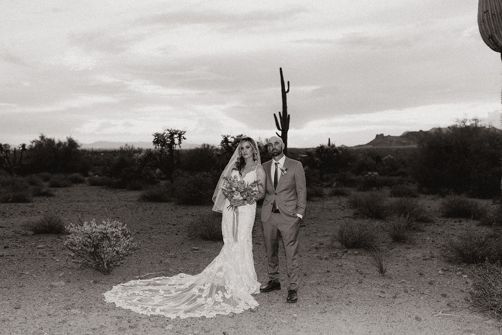 bride and groom pose in lost dutchman state park