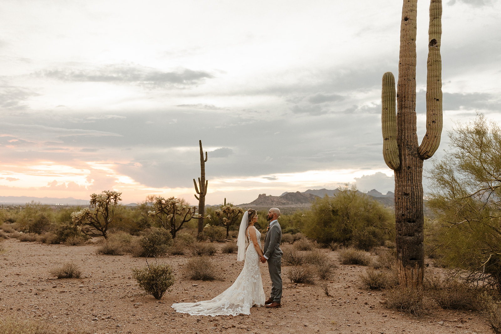 Stunning bride and groom pose at lost dutchman state park after their dreamy AZ wedding day