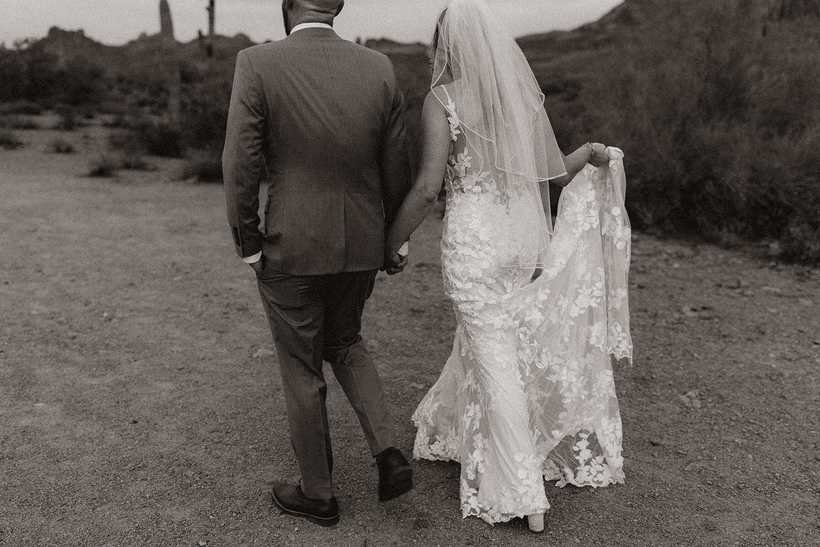 bride and groom walk together in the Arizona desert