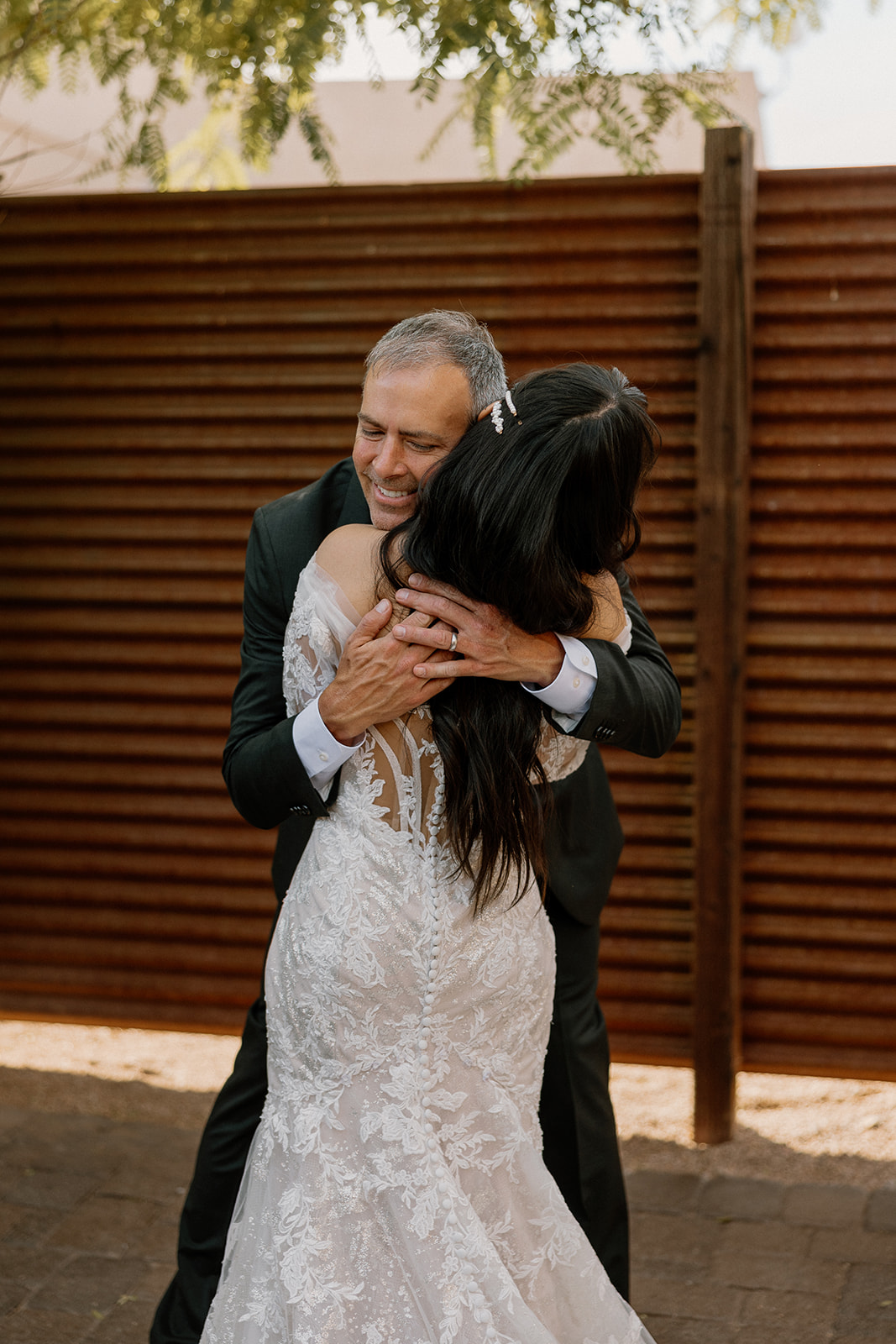 bride hugs her dad in a heartwarming first look wedding photoshoot