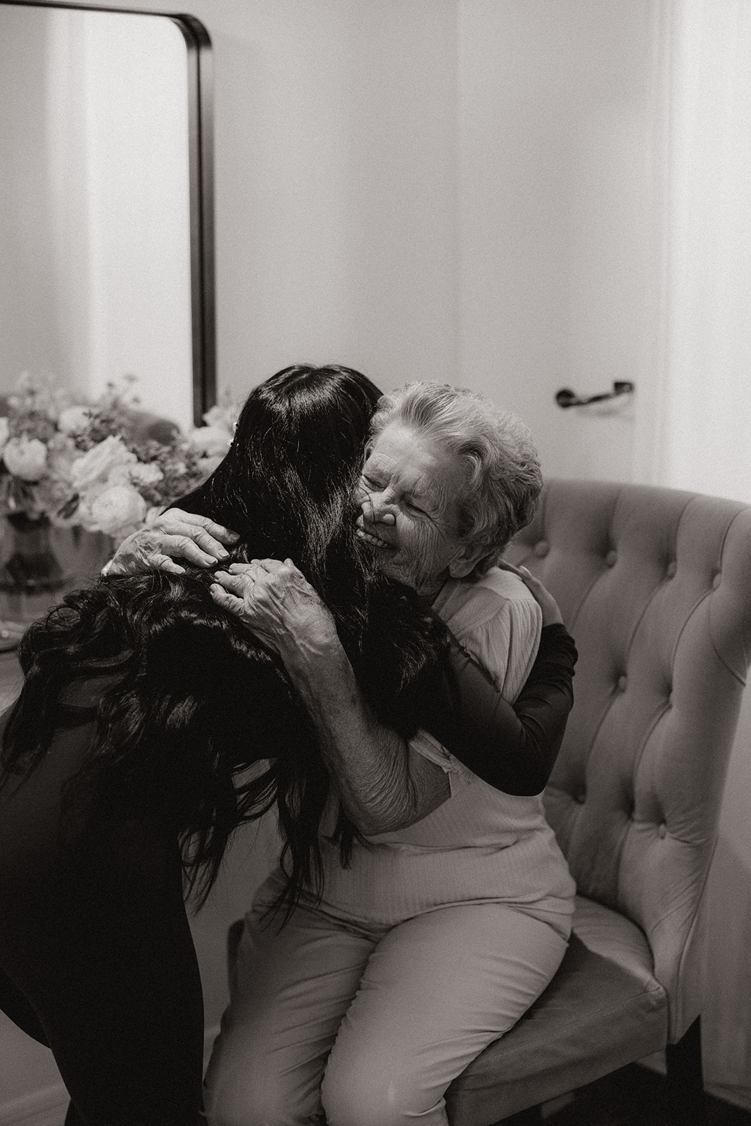 bride hugs her grandmother as she prepares for her stunning desert wedding day