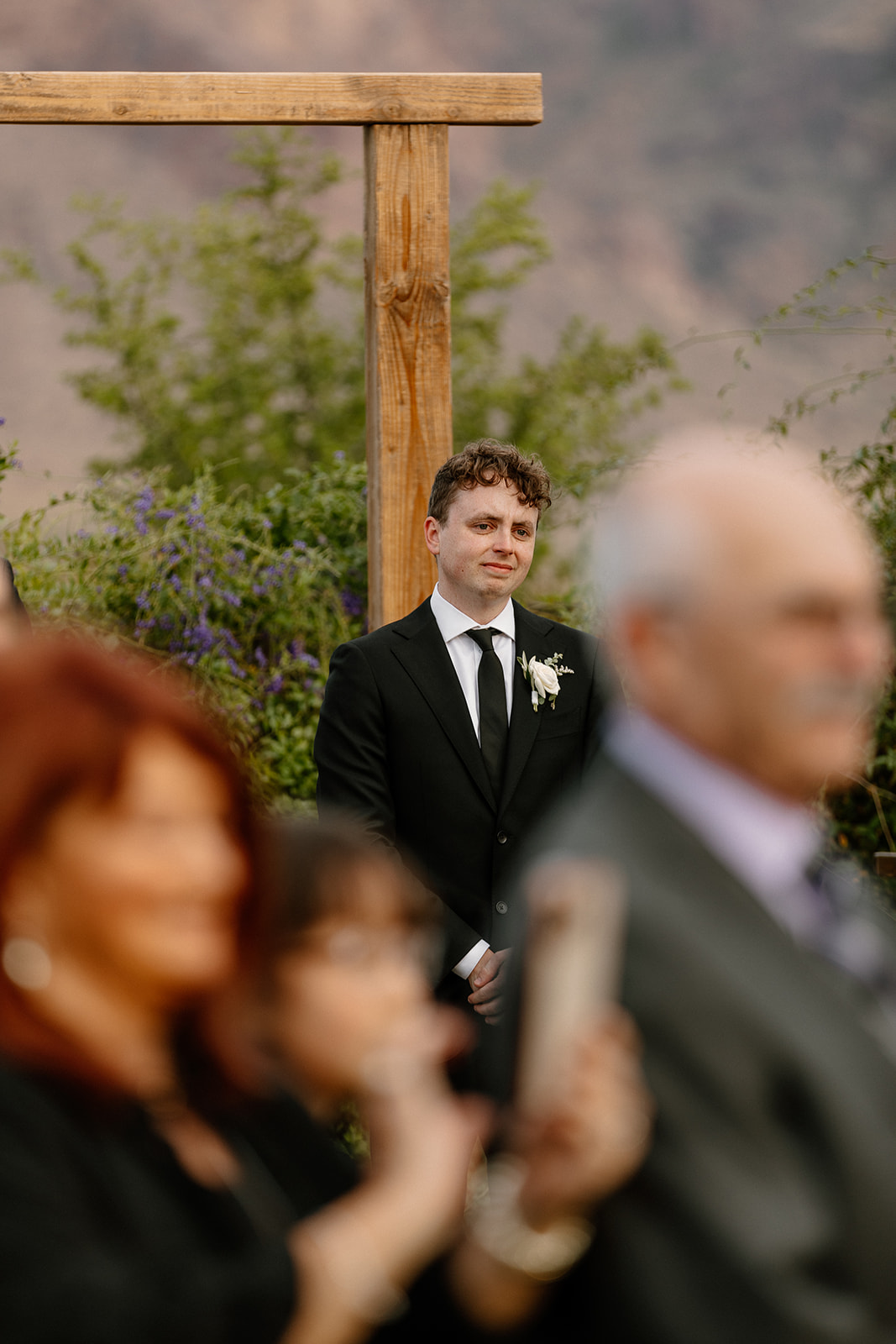 groom anxiously awaits as his stunning bride enters their dreamy wedding day