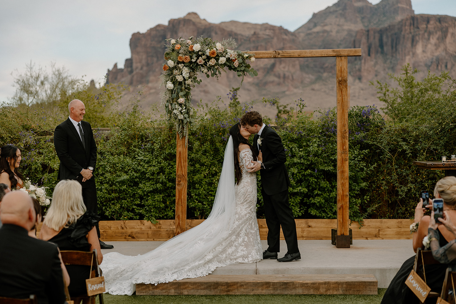 bride and groom share their first kiss as a married couple at the end of their dreamy Arizona desert wedding