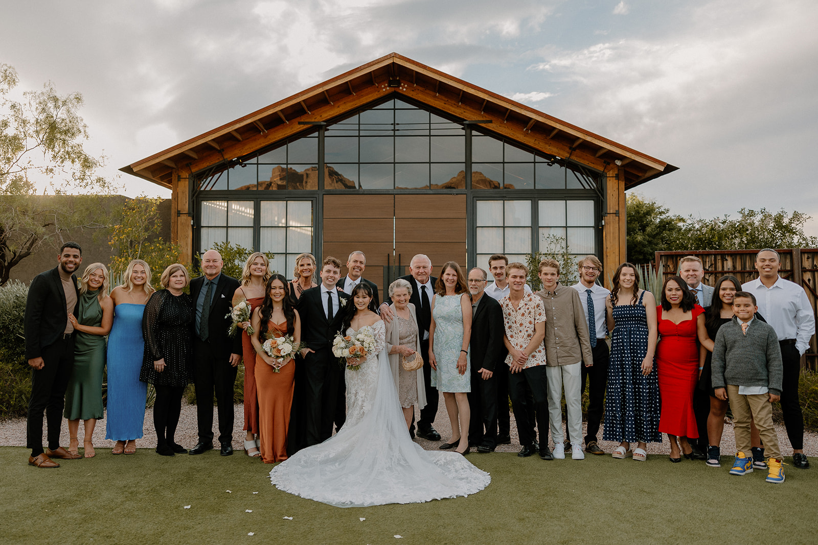 guests and wedding party pose together in front of the dreamy Paseo wedding venue 