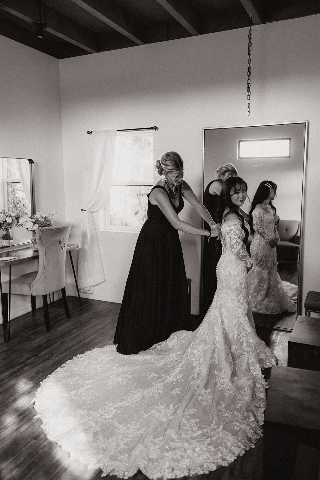 Bride gets help zipping her wedding dress on her boho Arizona wedding day