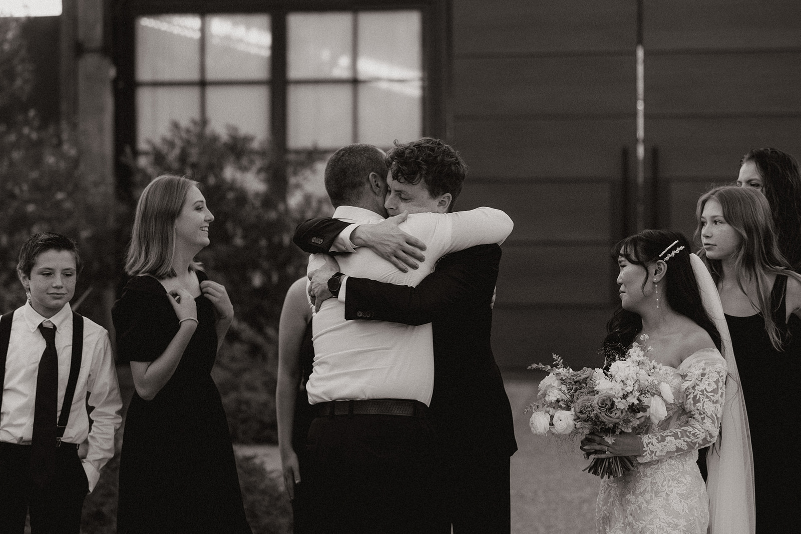 groom embraces a friend at the stunning Arizona wedding reception