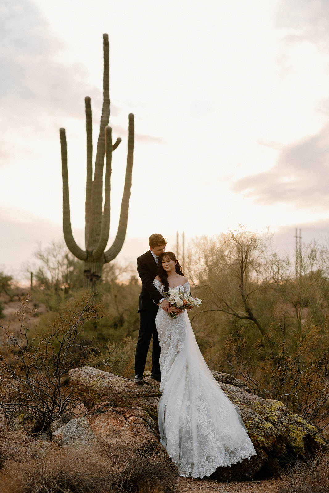 stunning bride and groom poses in the Arizona desert