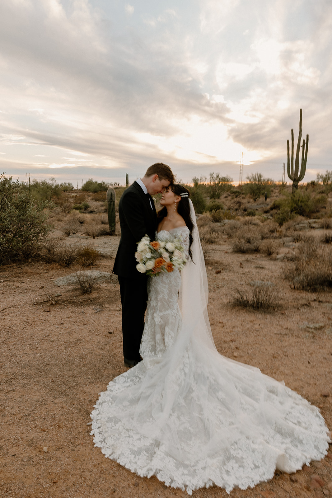 bride and groom pose at golden hour after their dreamy Arizona wedding day