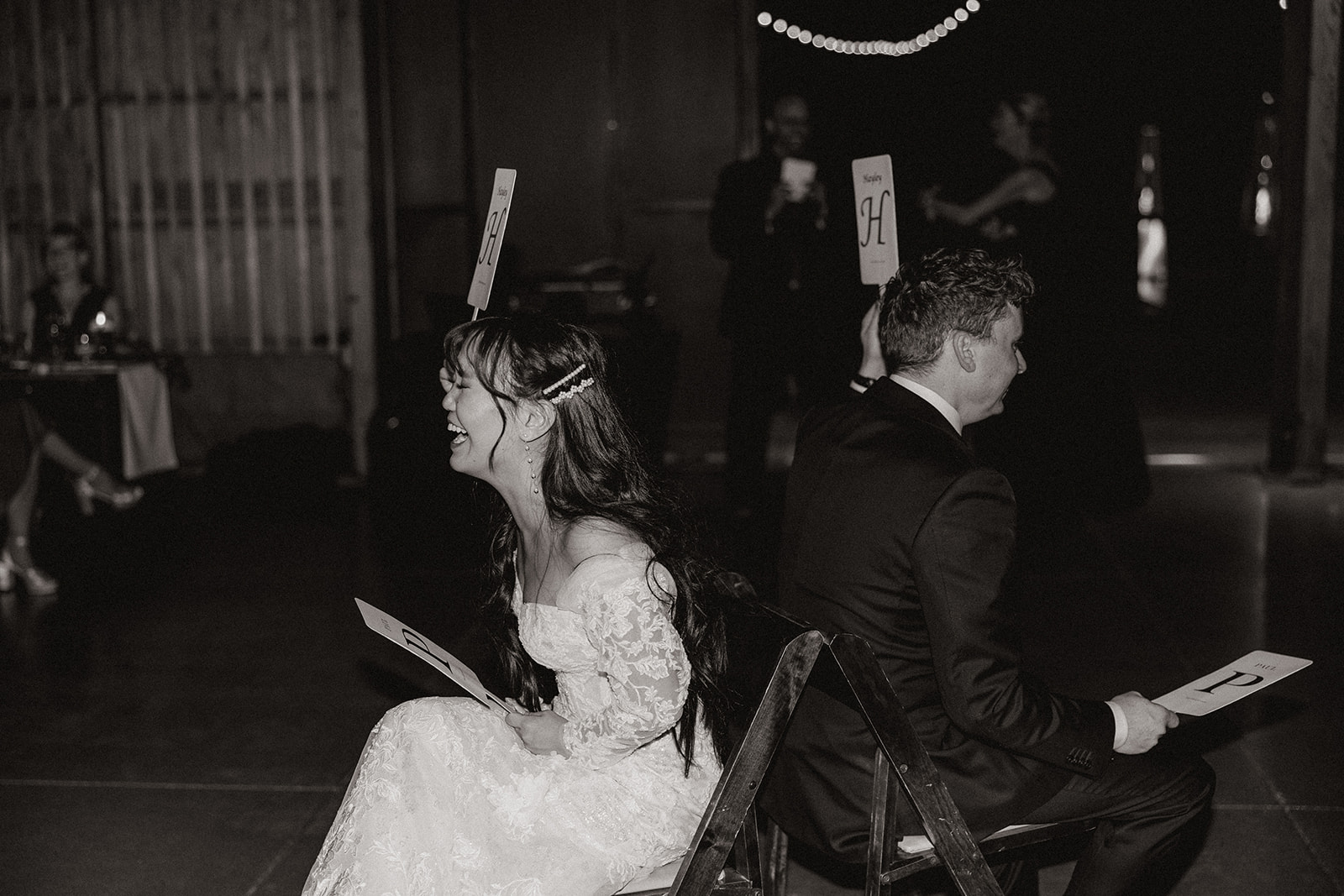 bride and groom play a game during the dreamy wedding reception