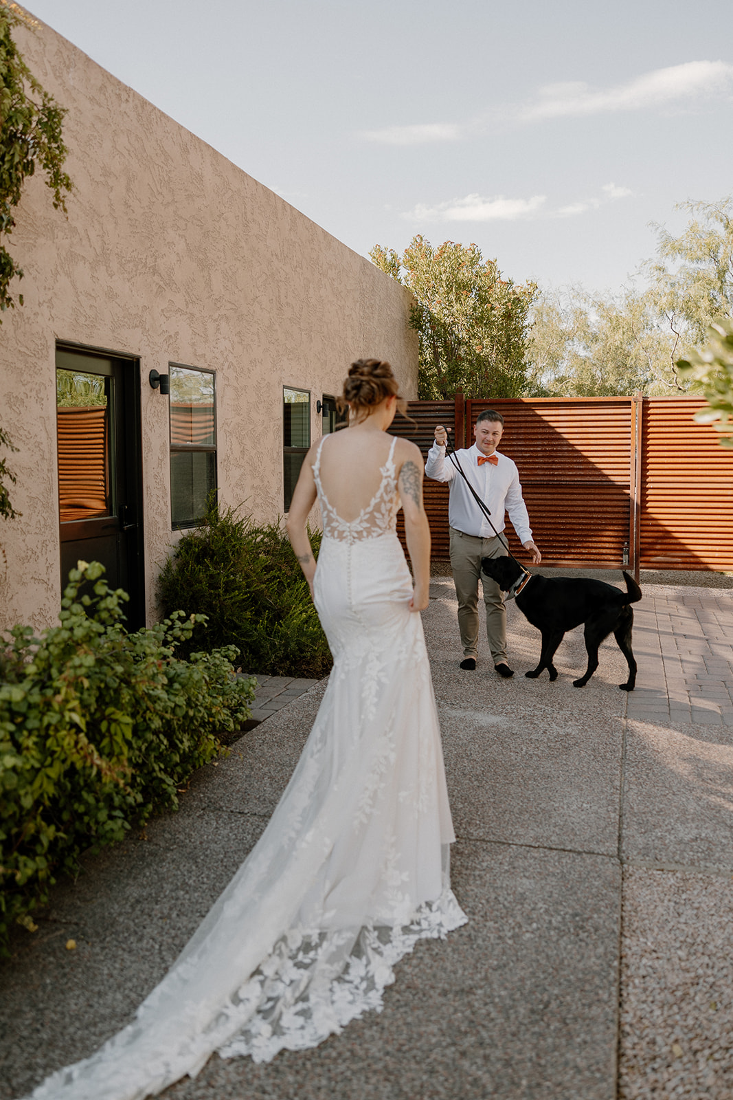handsome groom and their black lab greet the beautiful bride for first look photos