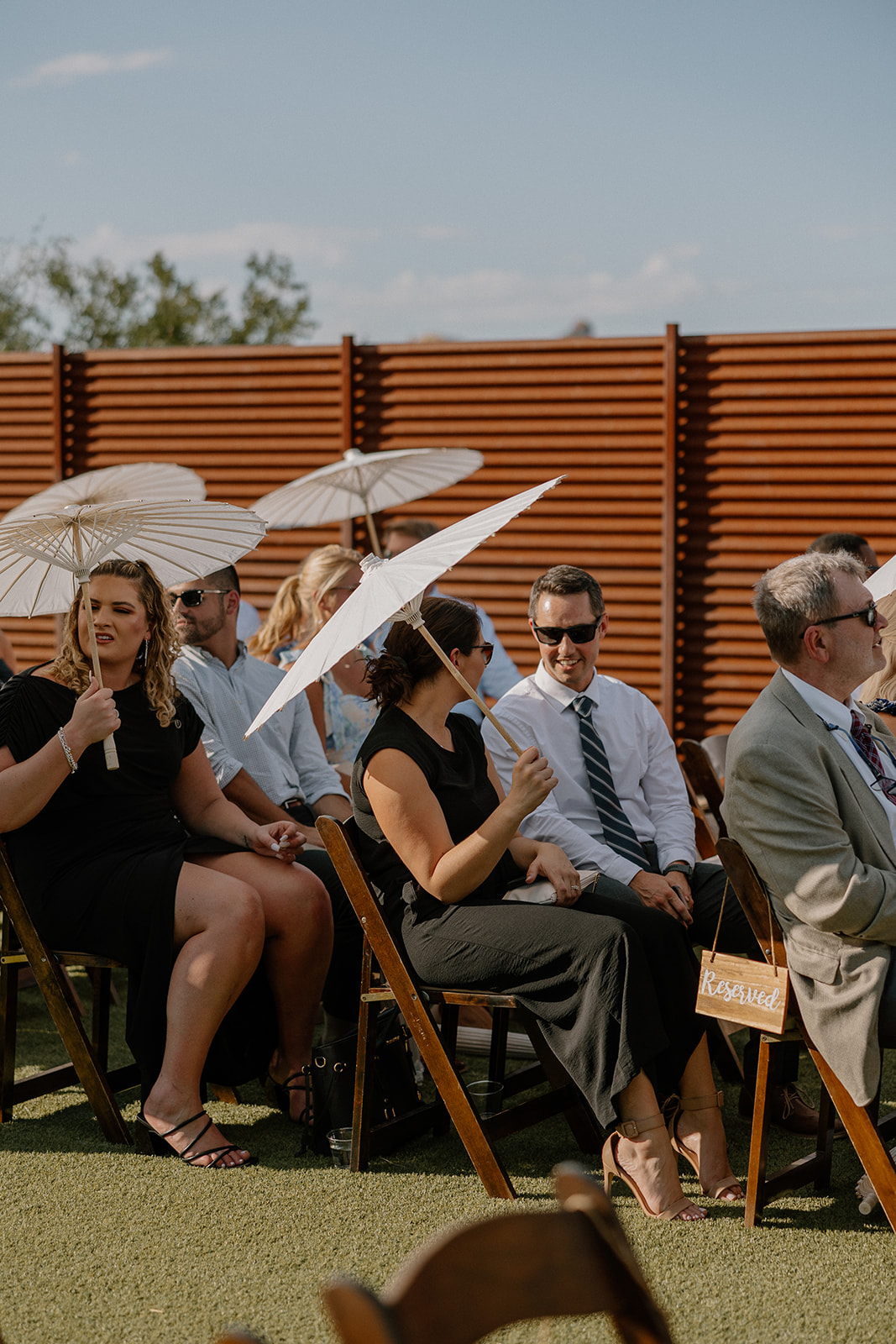 Guests sit and watch as the Arizona desert wedding takes place