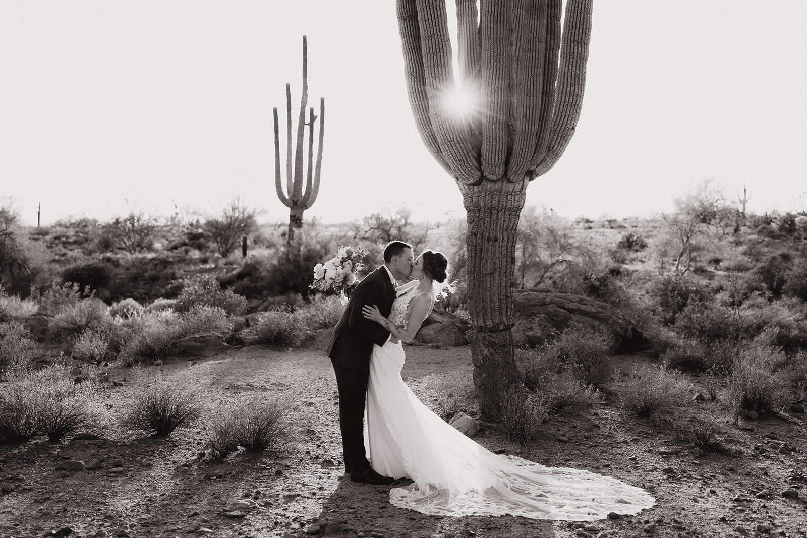 Stunning bride and groom pose in the desert after their stunning Arizona wedding
