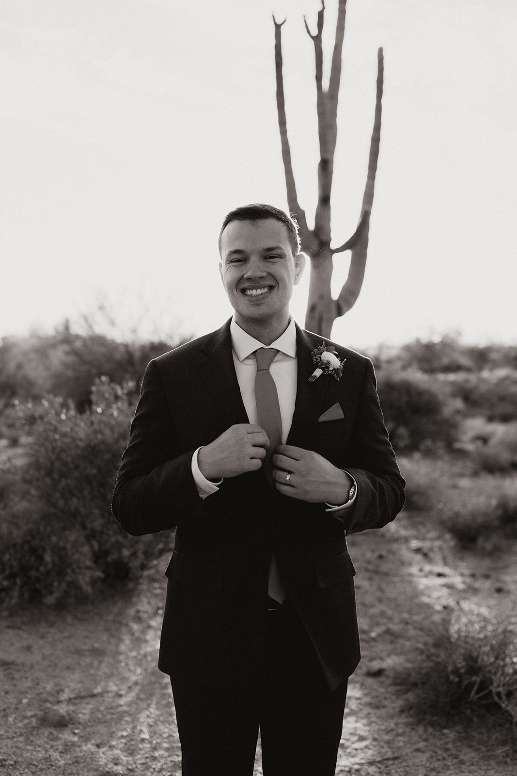 Groom poses in the desert after his stunning Arizona desert wedding