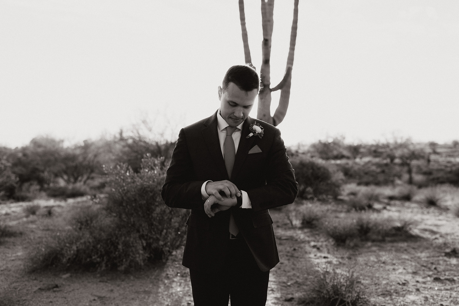 Groom poses in the desert after his stunning Arizona desert wedding