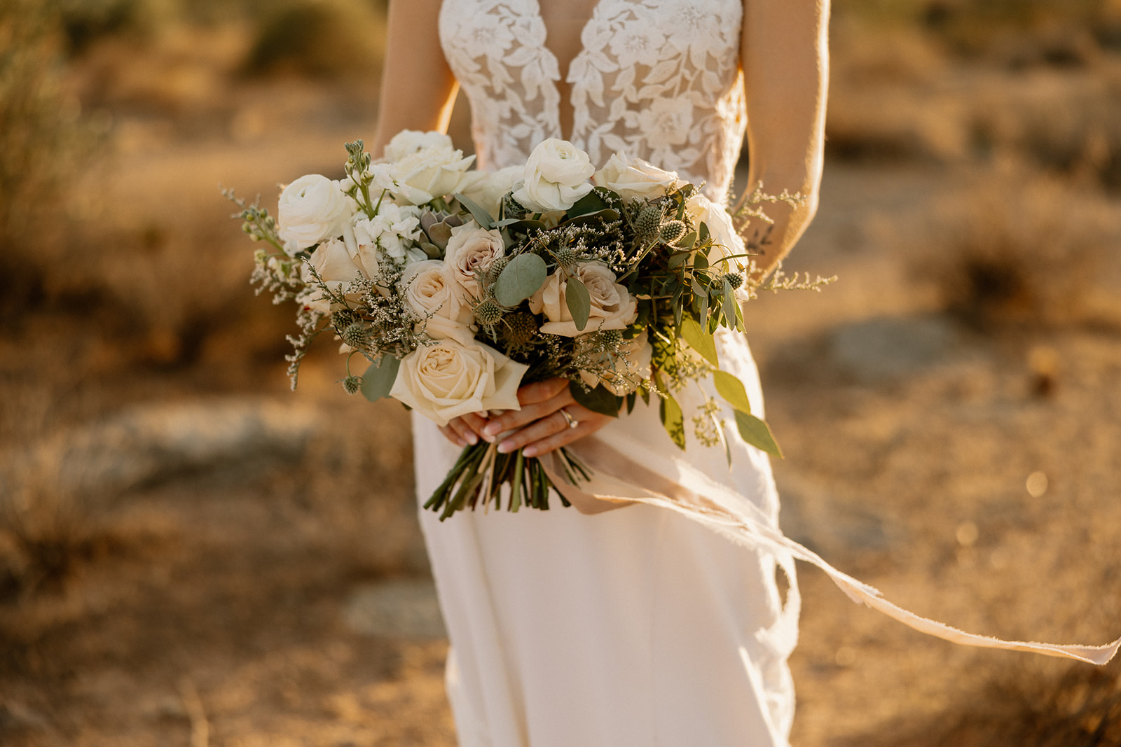 Bride poses in the desert after her stunning Arizona wedding