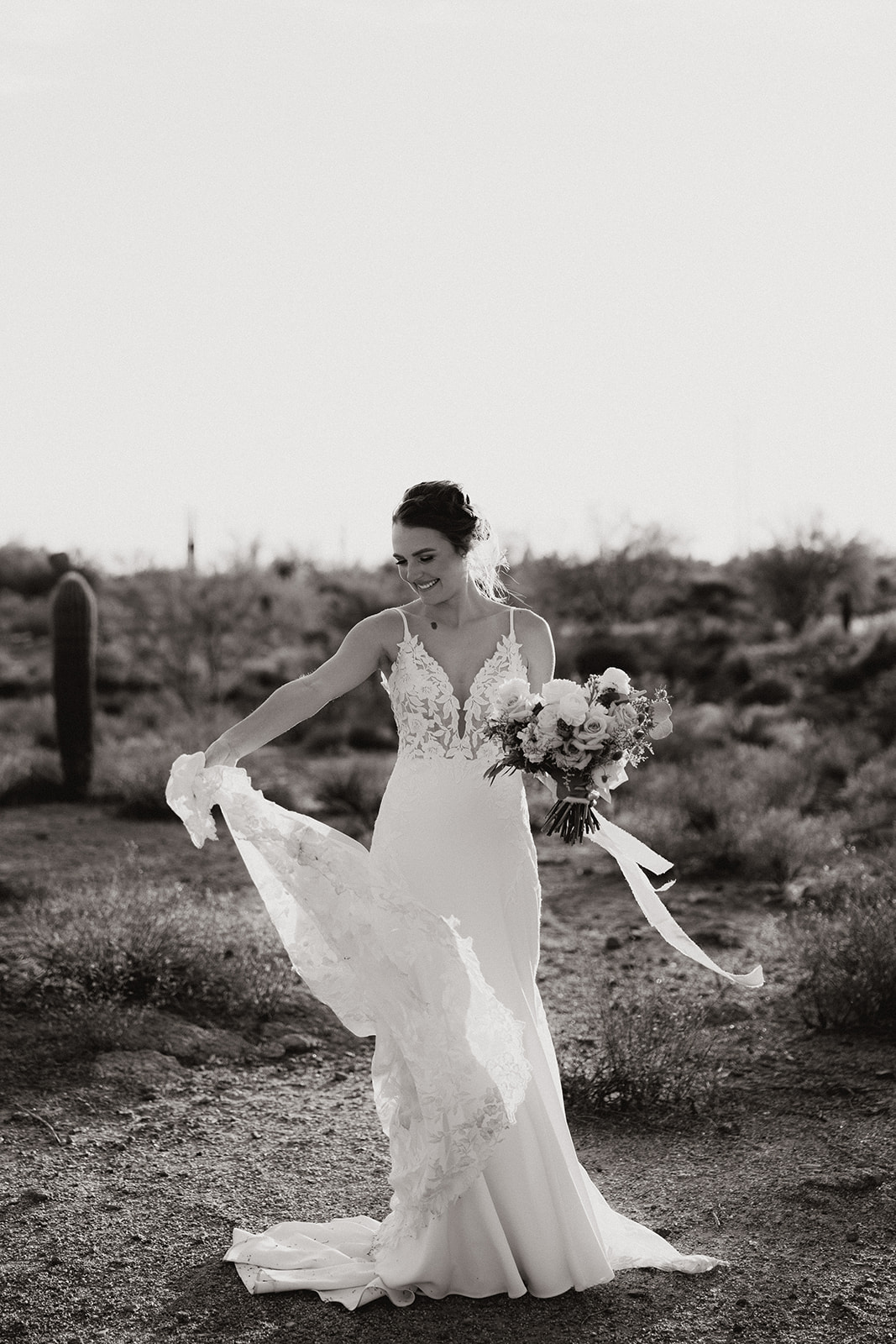 Bride poses in the desert after her stunning Arizona desert wedding