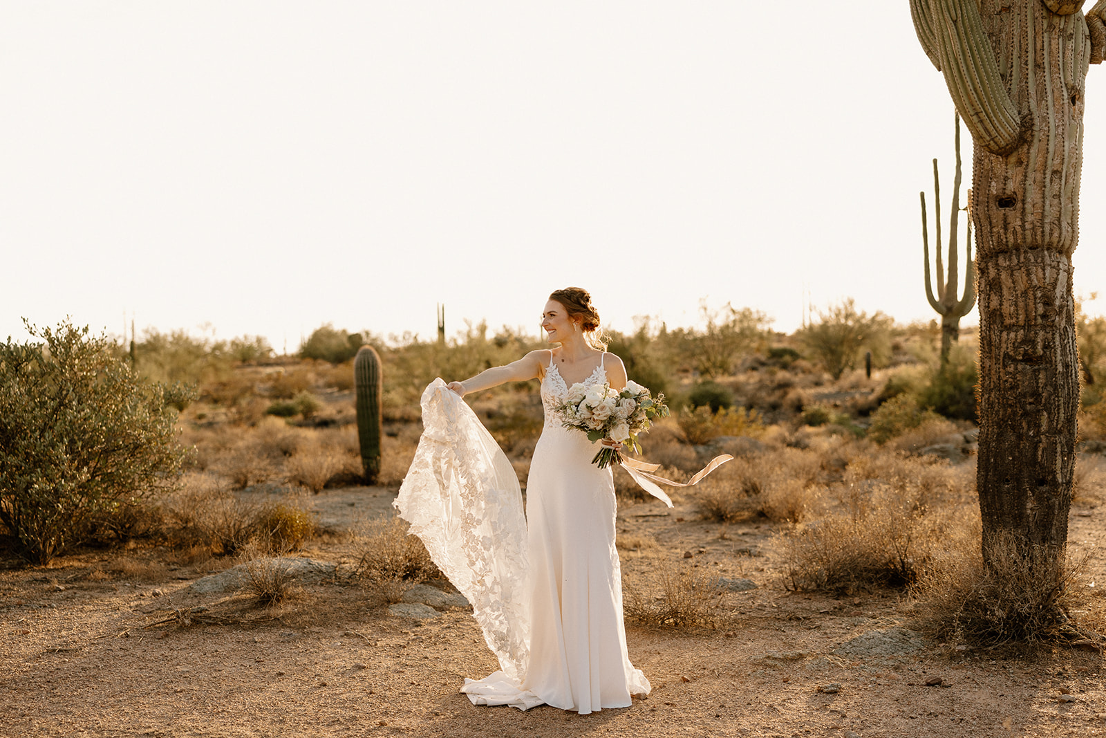 Bride poses in the desert after her stunning Arizona wedding