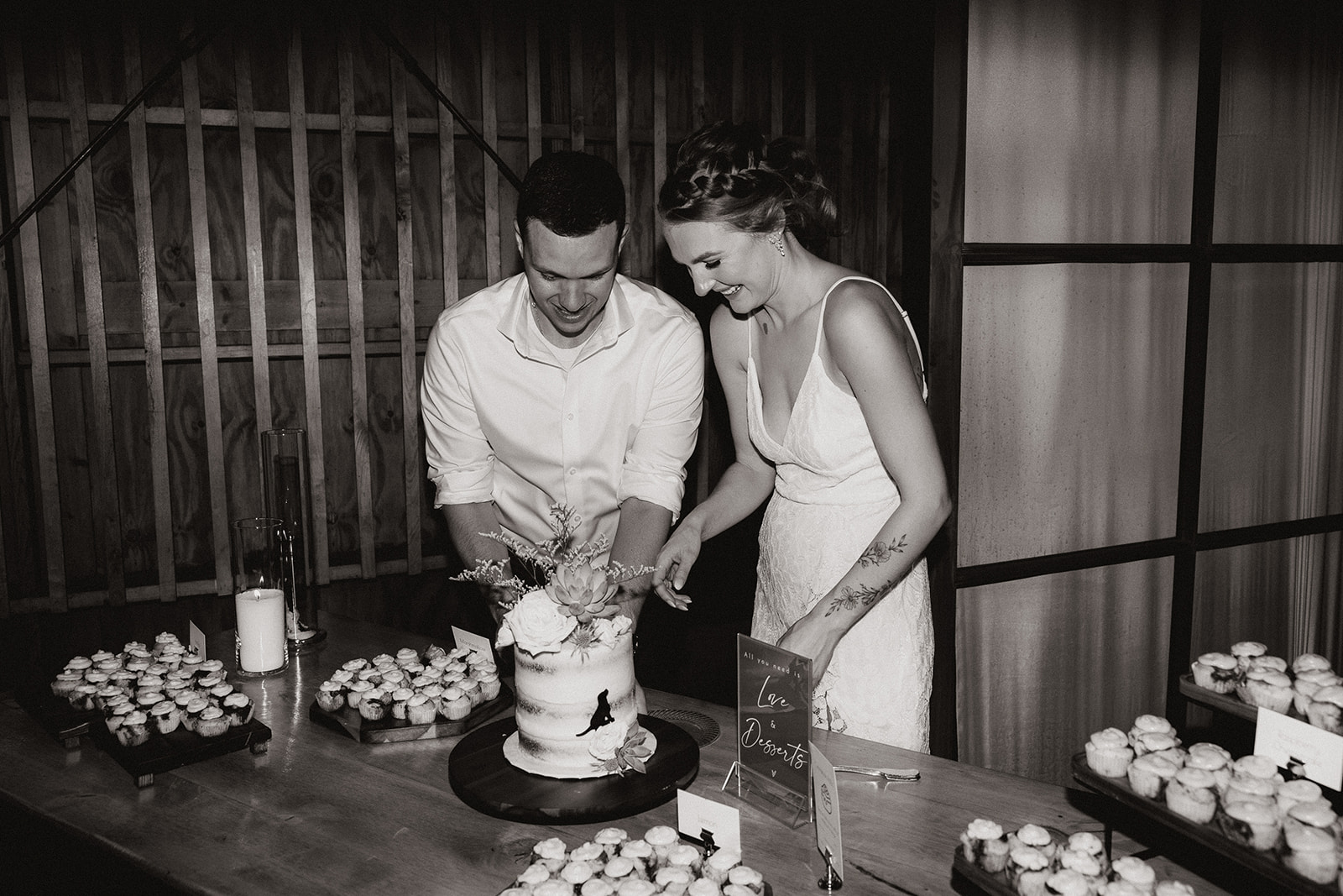 Bride and groom cut their wedding cake together