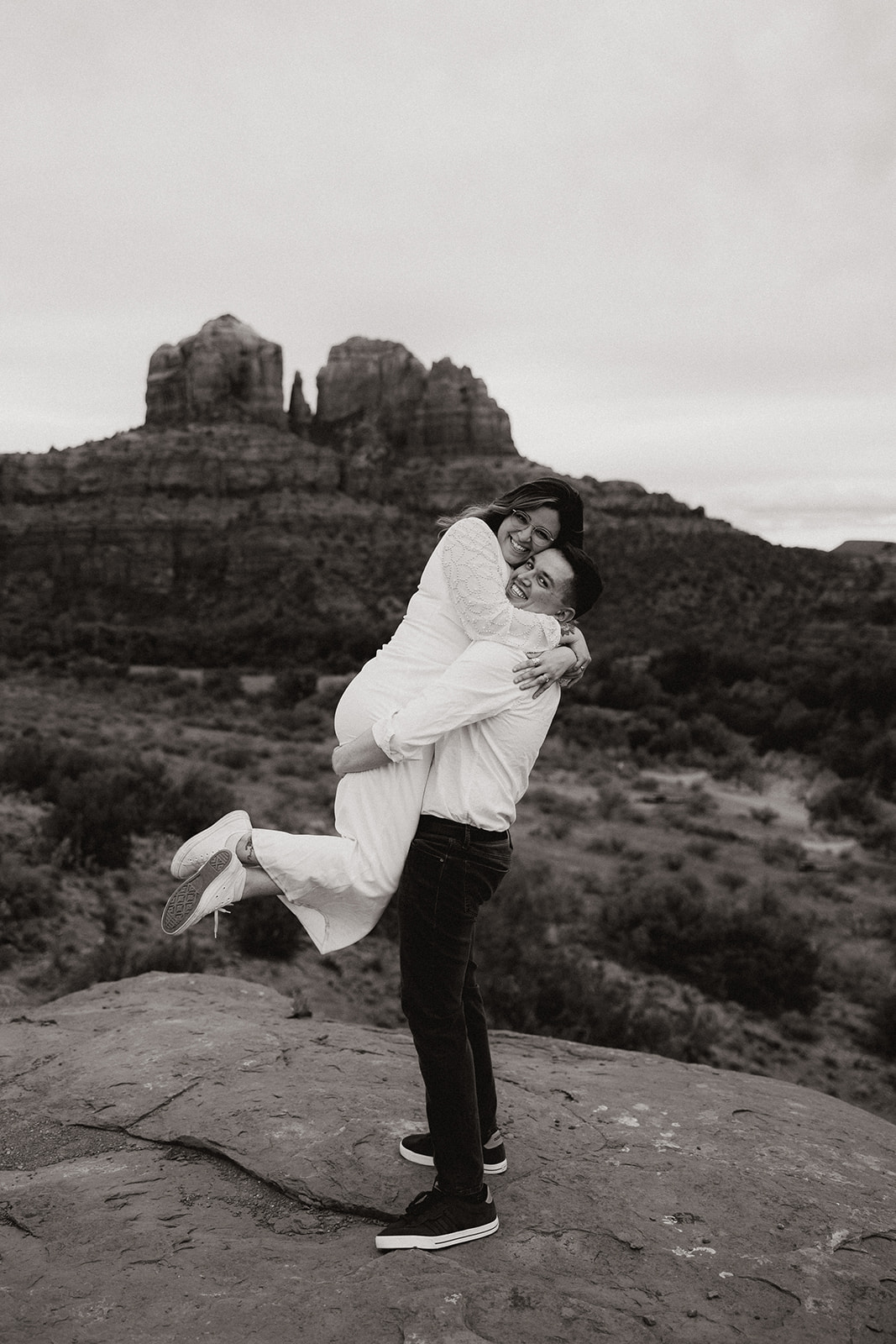 Beautiful couple share a kiss and intimate moment during their stunning Arizona engagement photoshoot
