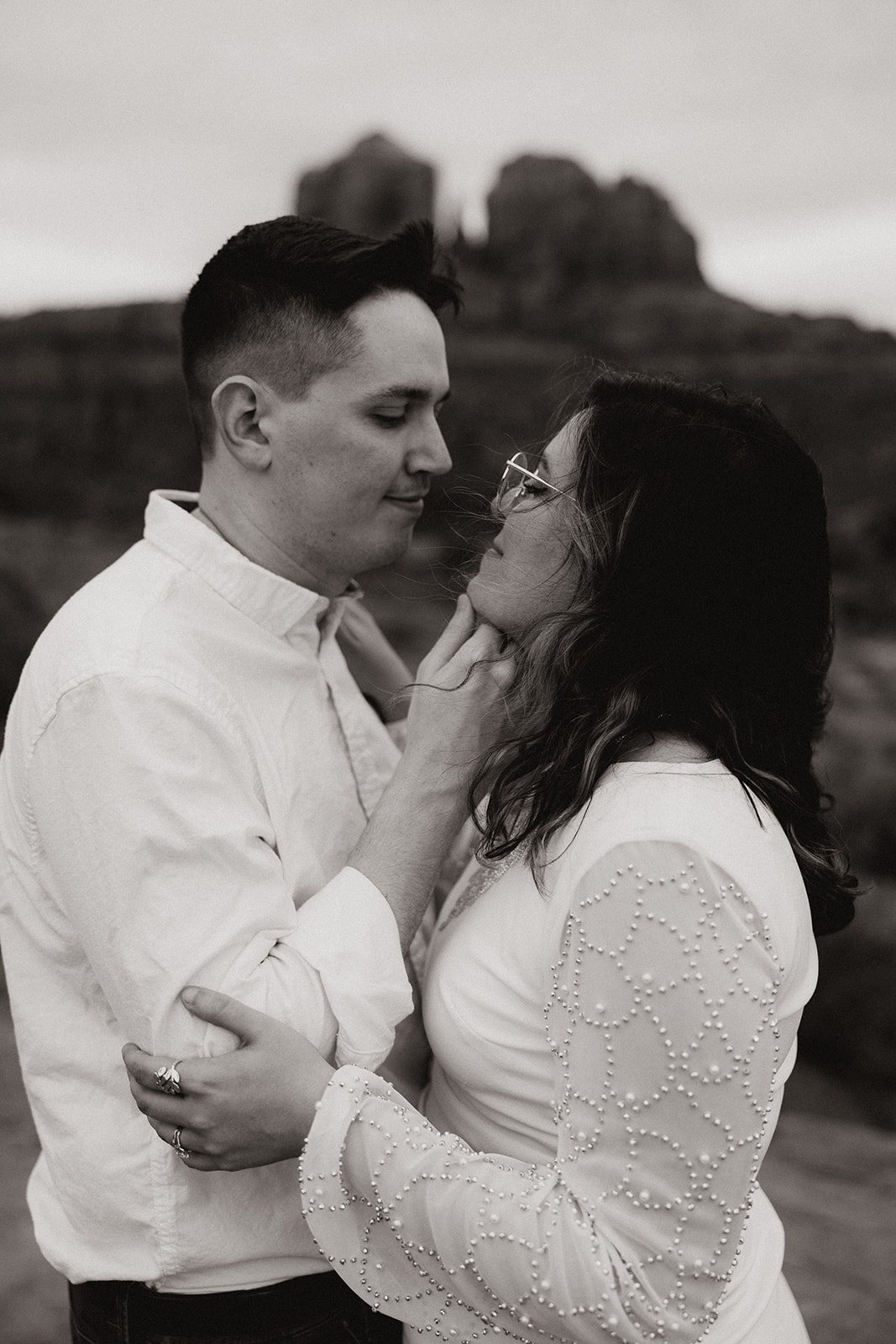 Beautiful couple share a kiss and intimate moment during their stunning Arizona engagement photoshoot