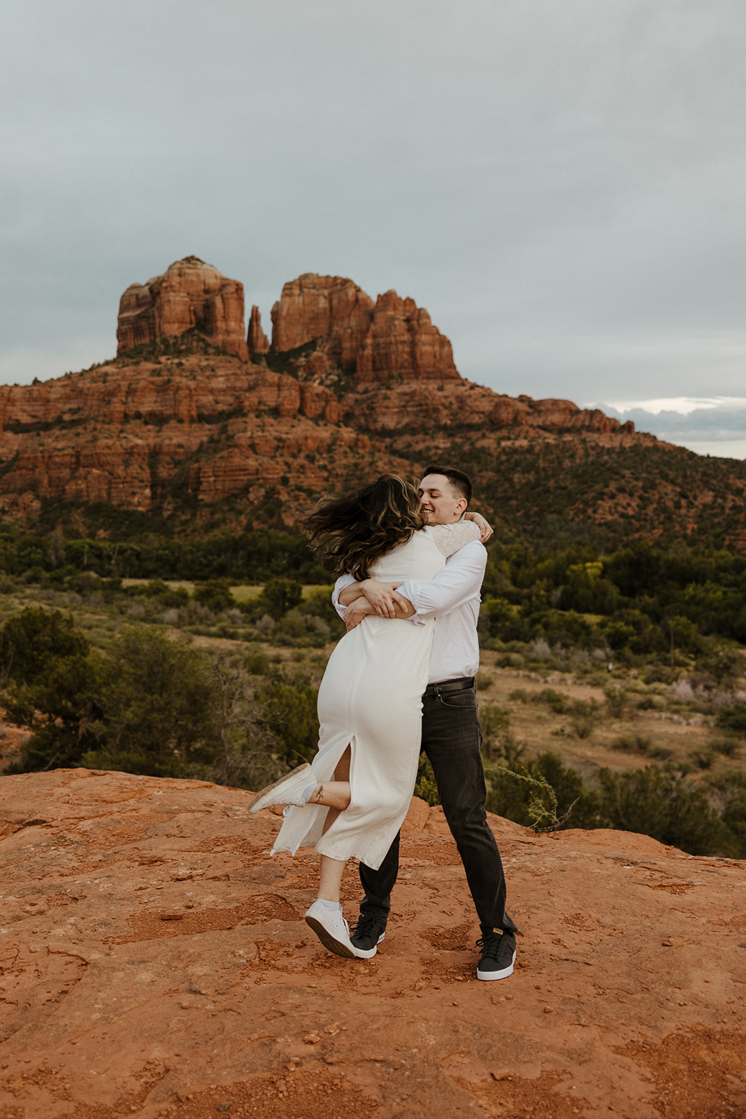 Stunning couple pose together during their beautiful Sedona engagement photoshoot with the Arizona nature in the background