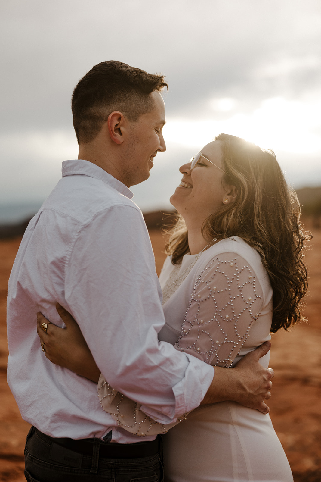 Beautiful couple share a laugh during their dreamy Sedona Arizona engagement photoshoot
