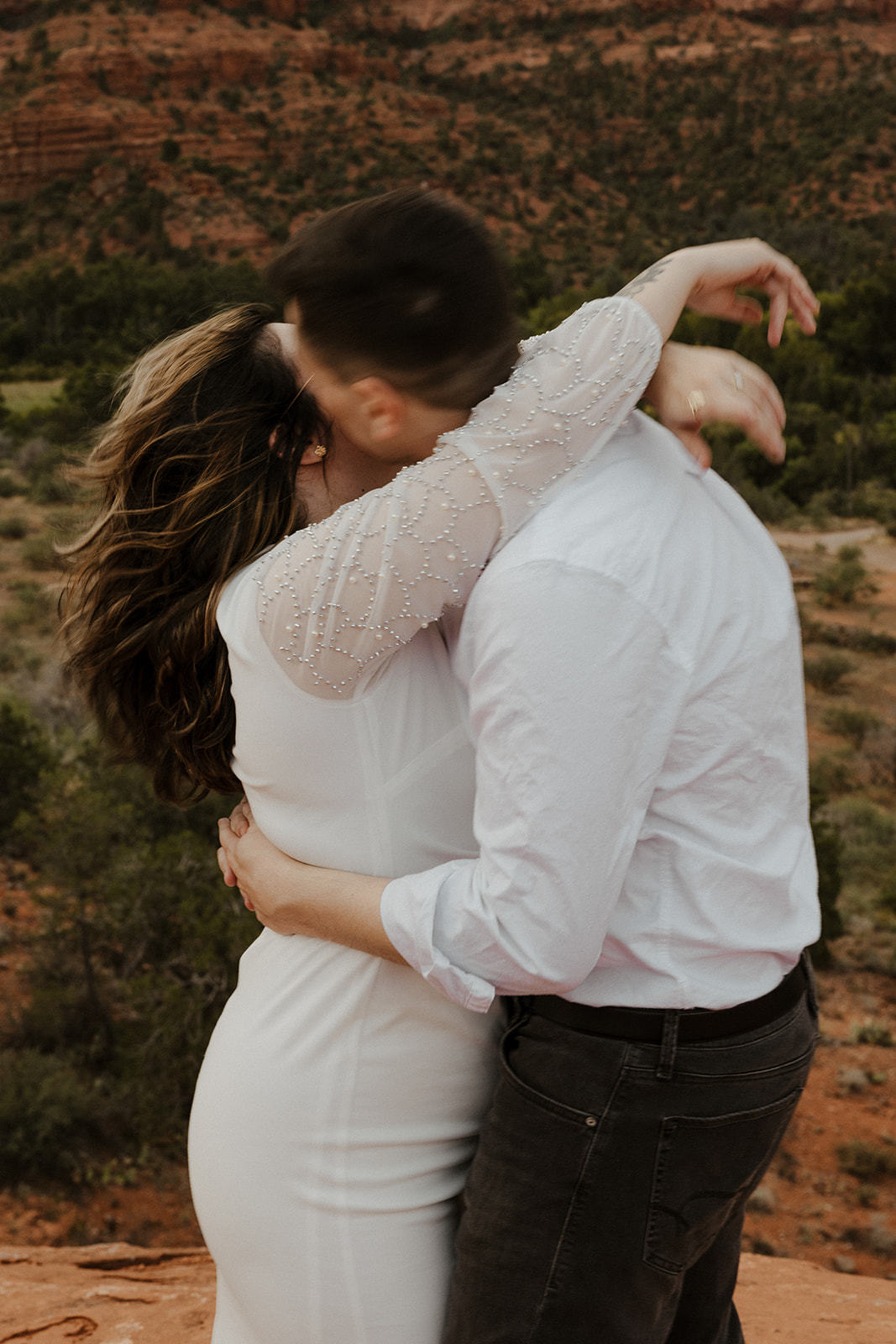Couple share a kiss and intimate moment during their dreamy Arizona engagement photoshoot
