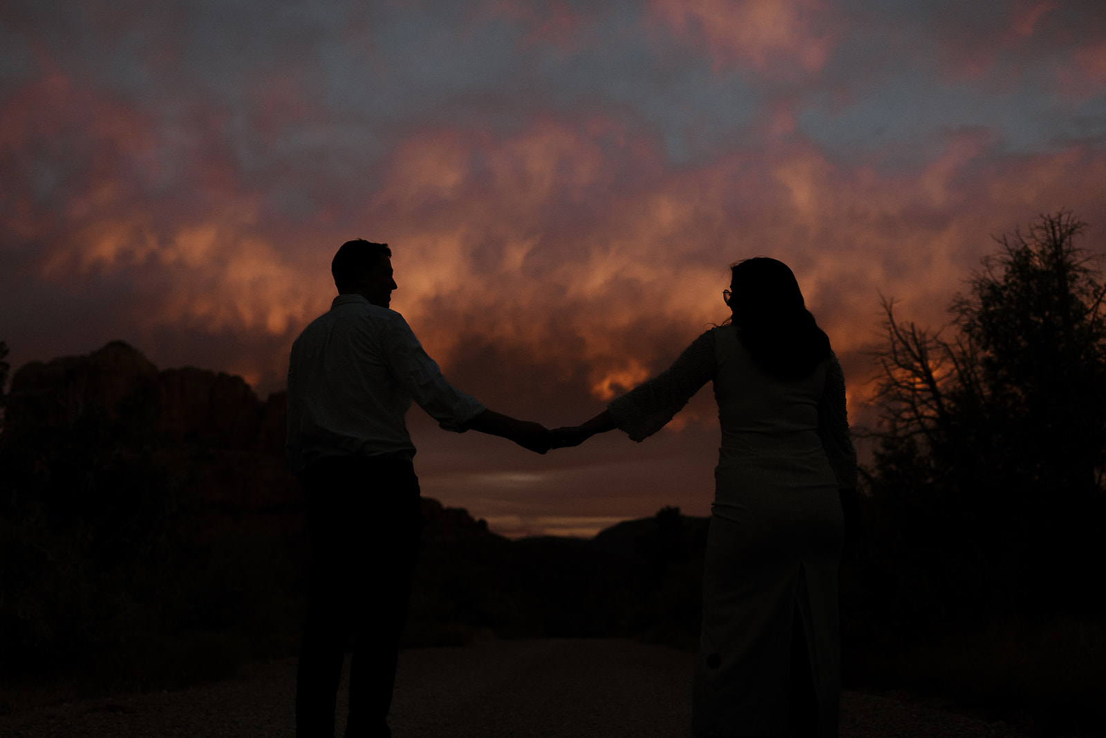 Dreamy photo of a couple holding hands with the Arizona sunset in the background