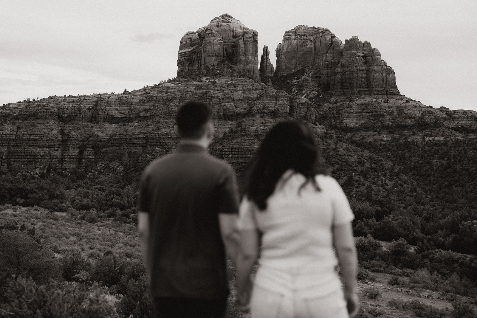 Stunning couple pose together during their beautiful Sedona engagement photoshoot with the Arizona nature in the background