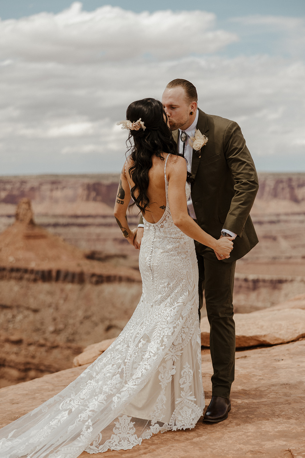 beautiful bride and groom share a kiss with the stunning Arizona nature in the background after their dreamy wedding at the red earth venue in Arizona!