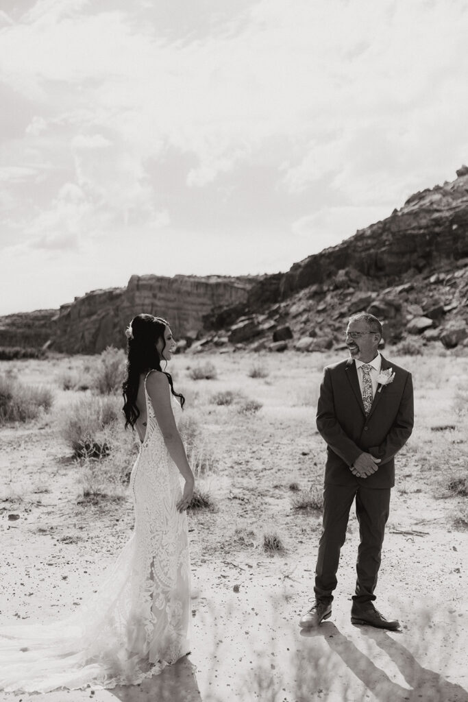 stunning first look photos of a bride and her father with the dreamy Arizona mountains in the background