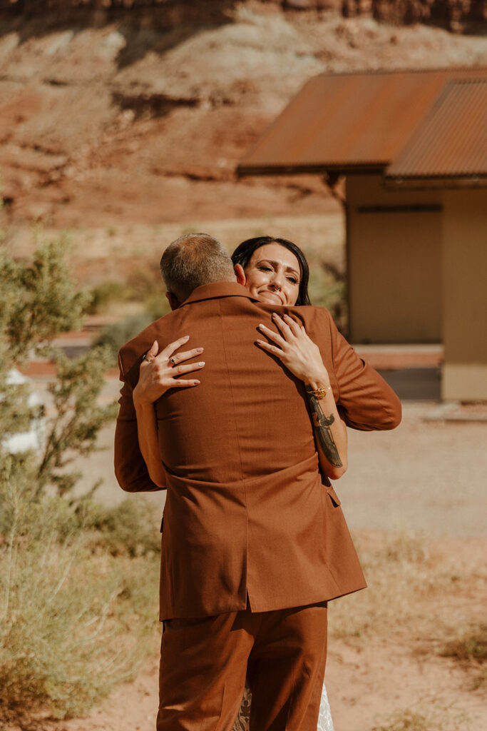 stunning first look photos of a bride and her father with the dreamy Arizona mountains in the background
