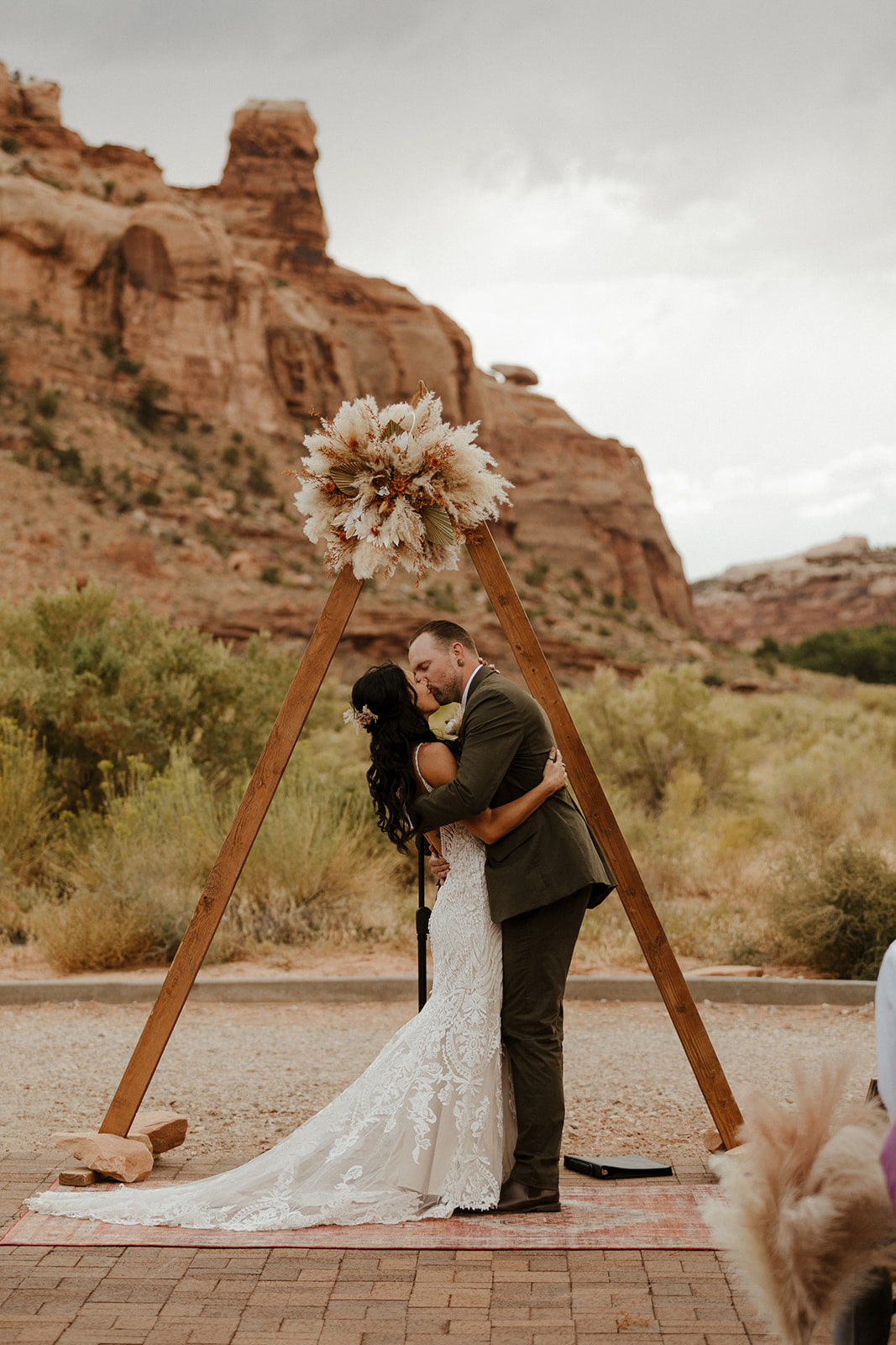 bride and groom kiss to seal their stunning Red Earth wedding in Arizona