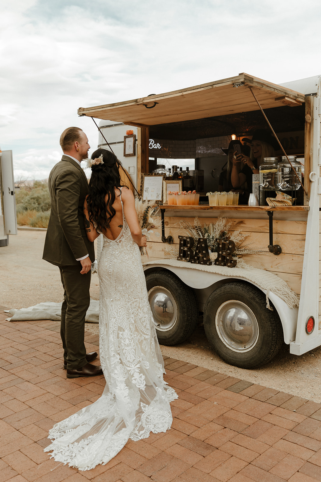 bride and groom put their orders in a the mobile bar!