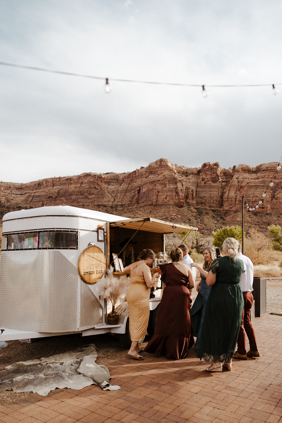 guests mingle as they wait at the mobile bar for their drinks
