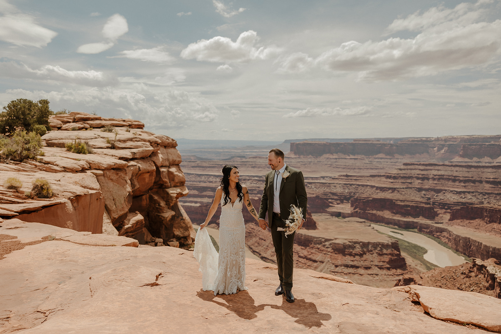 stunning bride and groom pose together with the stunning Arizona nature in the background after their dreamy wedding at the red earth venue in Arizona!